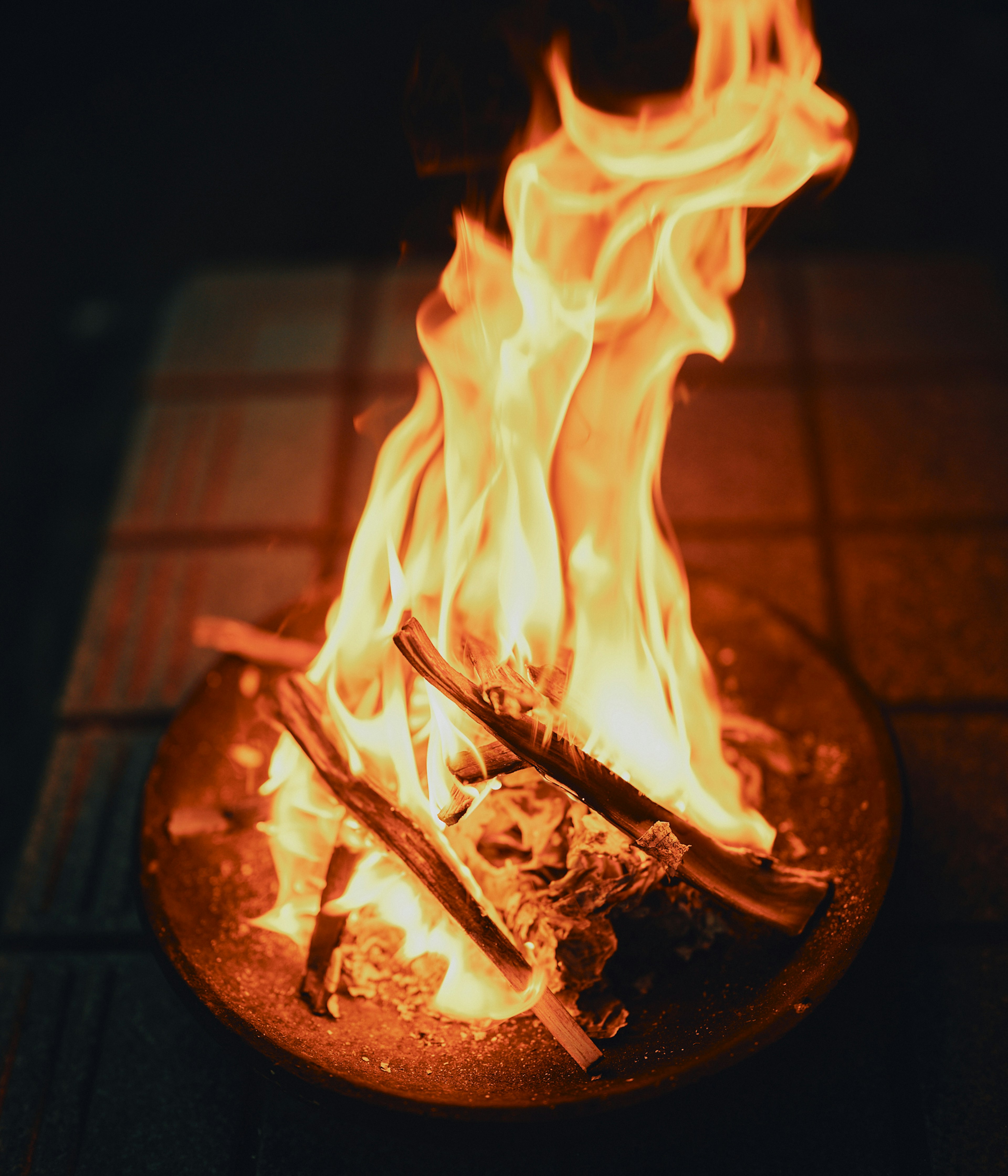 A warm scene of flames dancing on burning logs