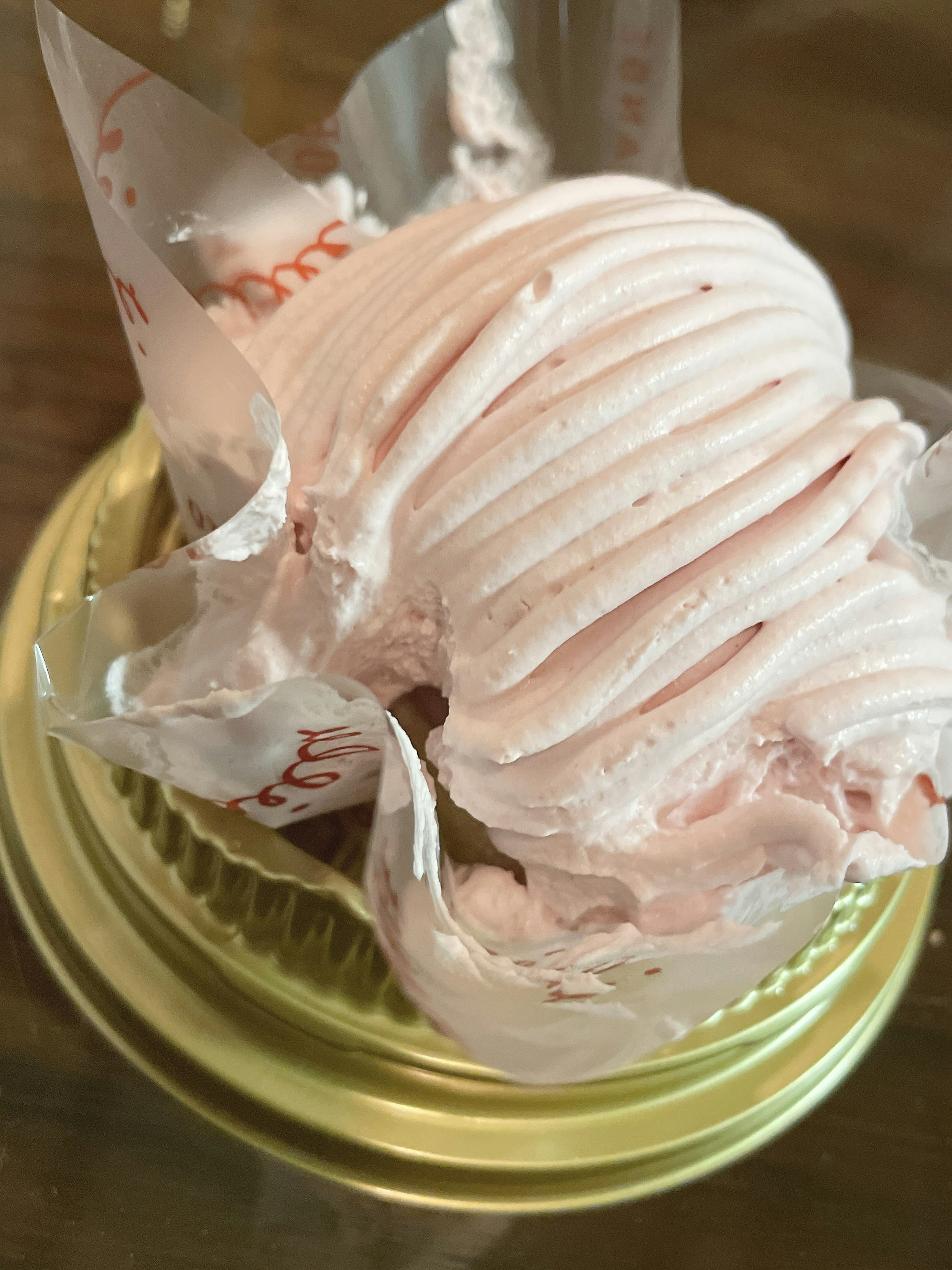 Pink ice cream served in a golden cup