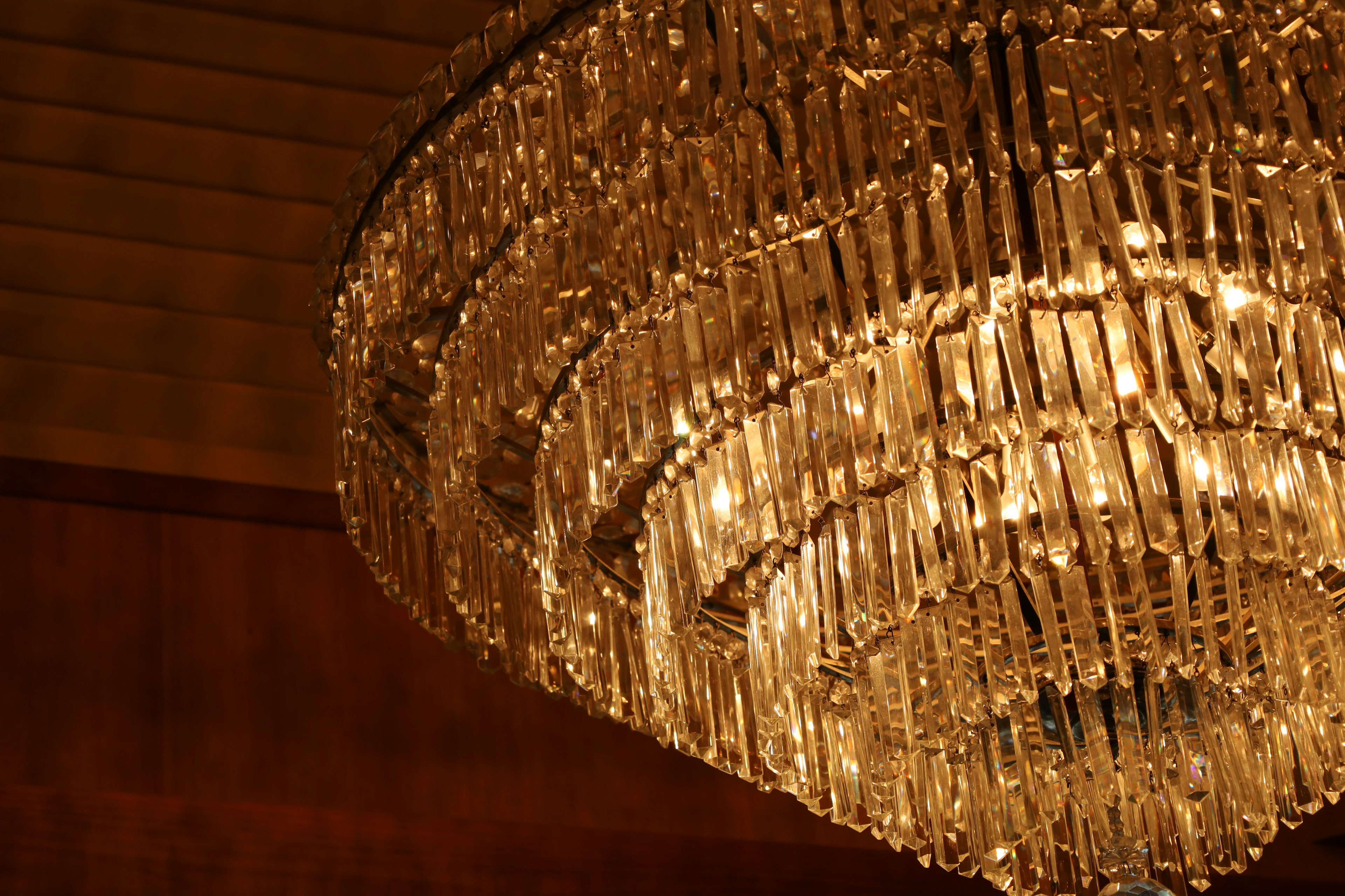 Close-up of an elegant chandelier warm light illuminating crystal pieces