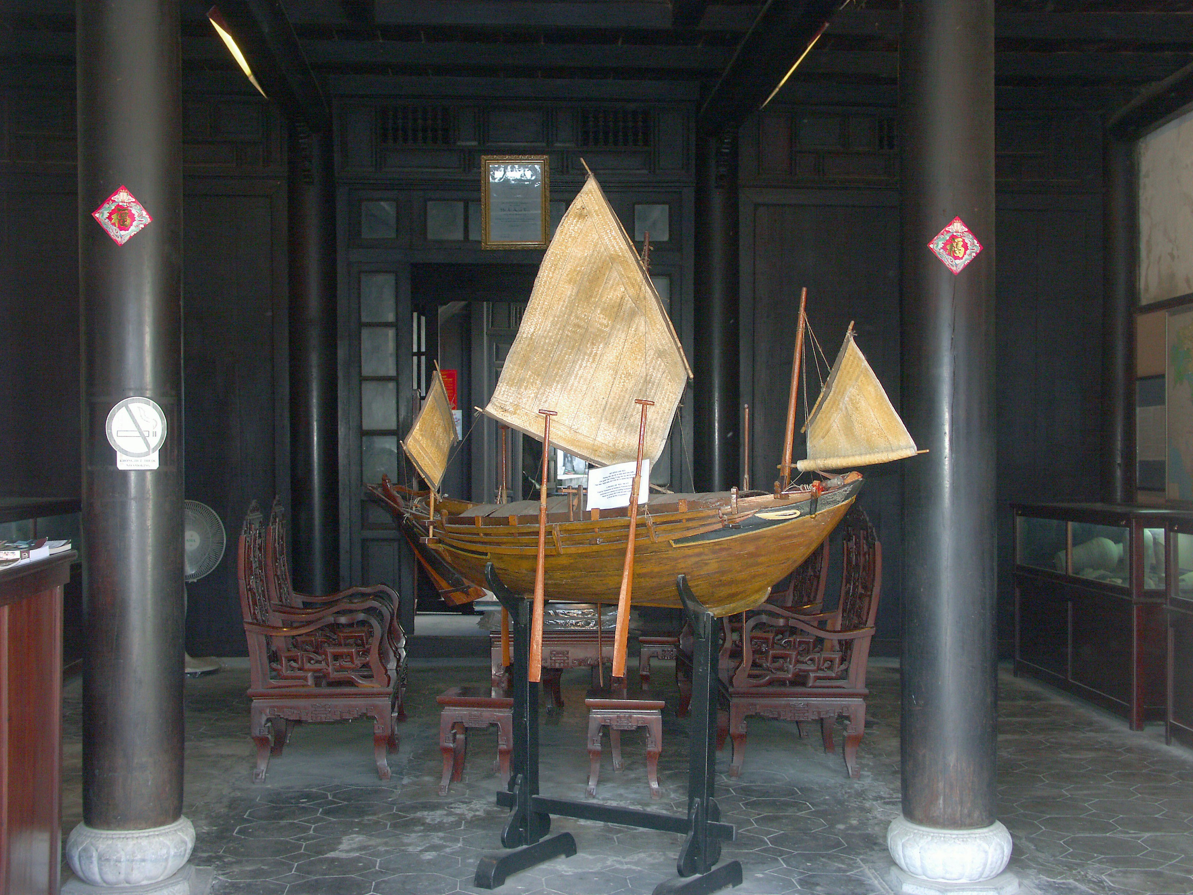 Interior view of a traditional wooden boat displayed with chairs