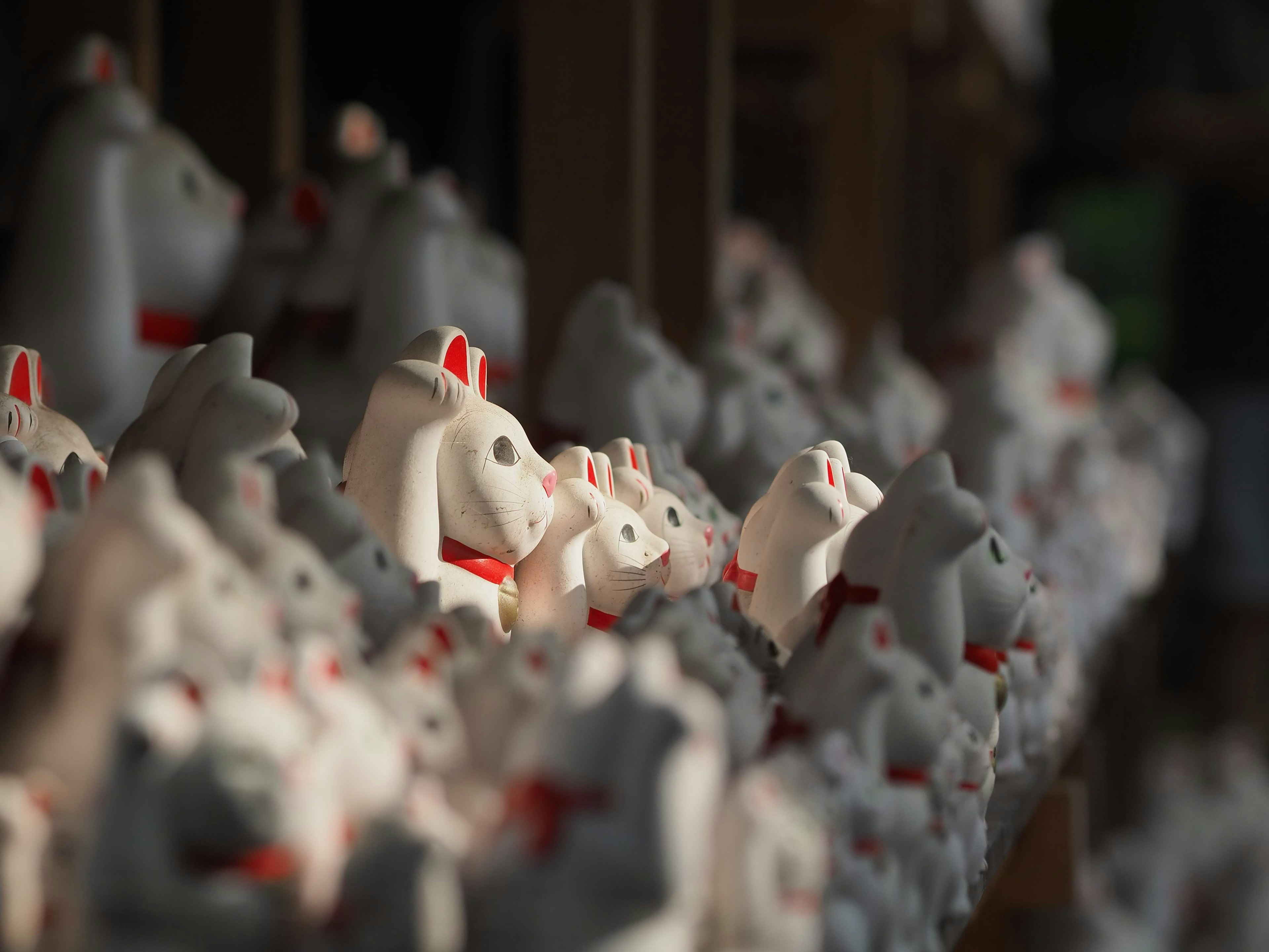 A row of white horse-shaped talismans with red accents