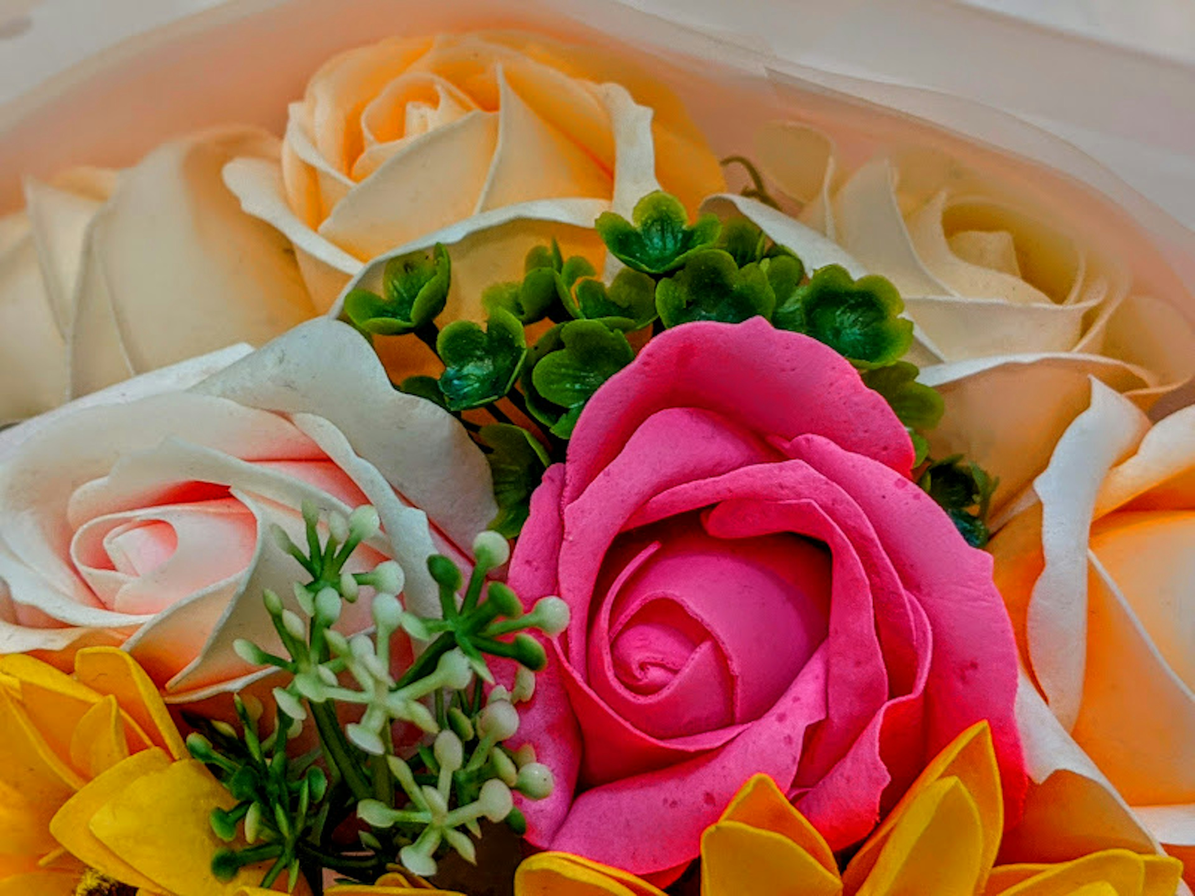 Colorful flower arrangement featuring pink and cream roses