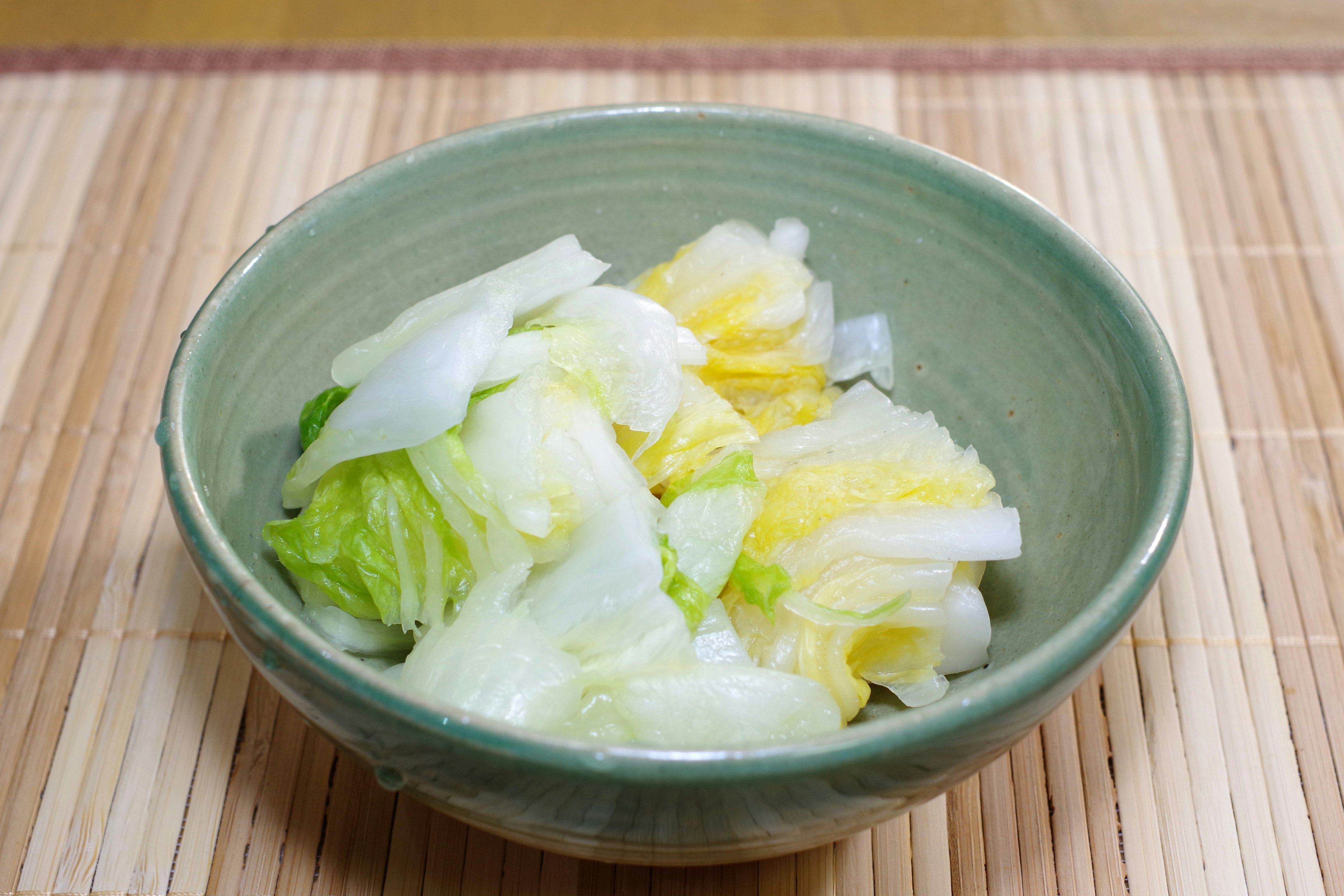 Fresh lettuce salad served in a green bowl