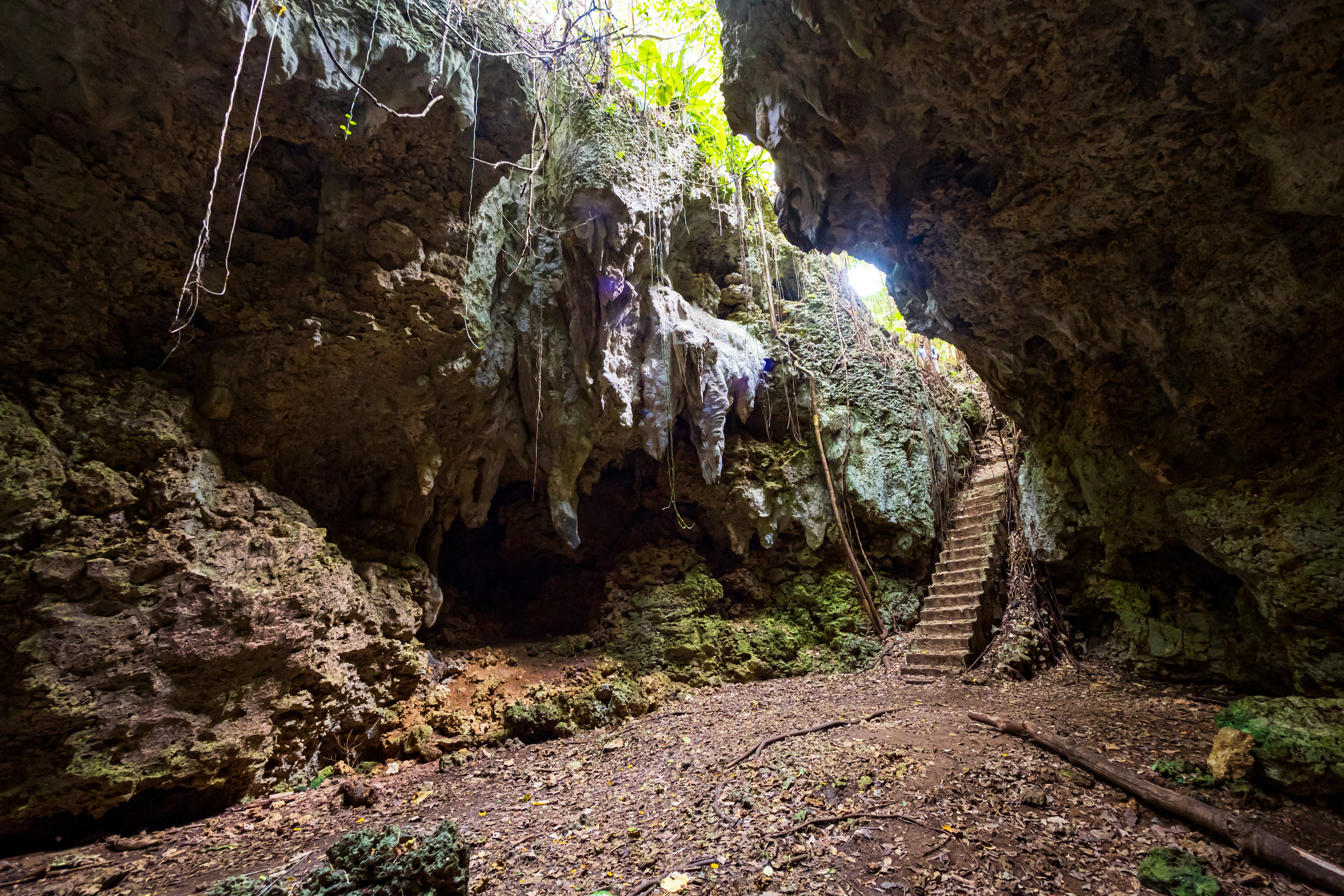 Interior of a cave with stairs and natural light streaming in