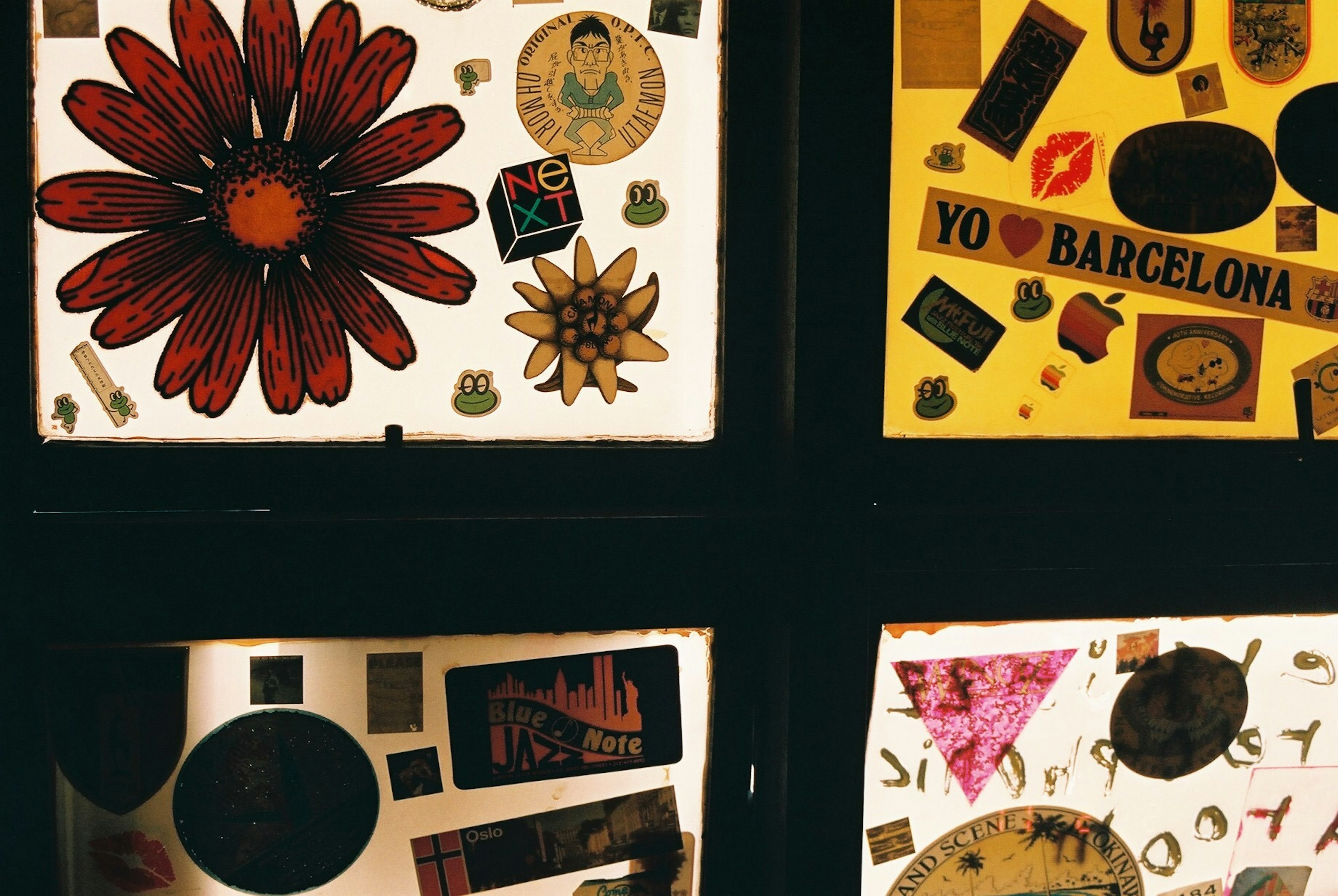 Collage of colorful stickers and decals on a window