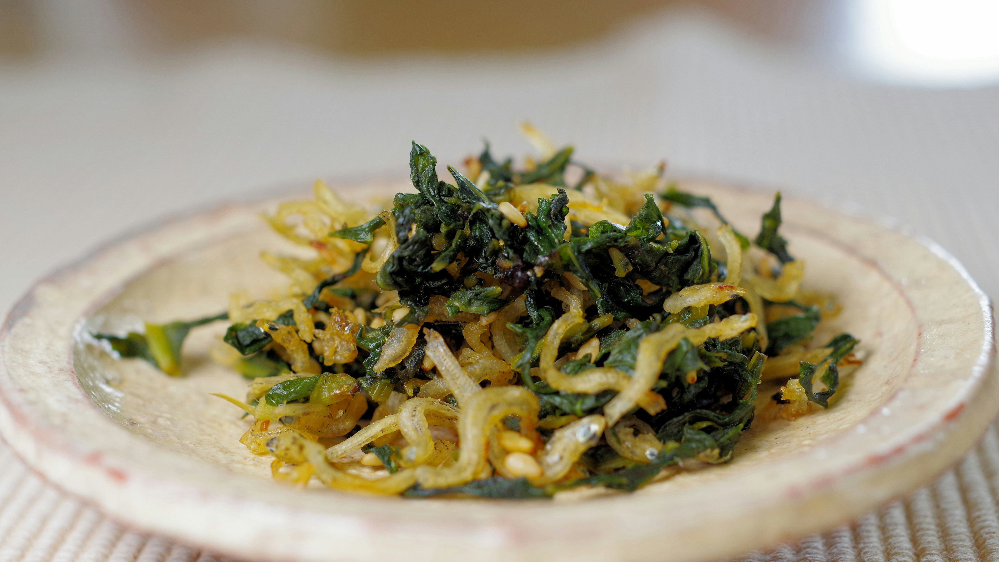 Dish of green vegetables and thin noodles on a plate