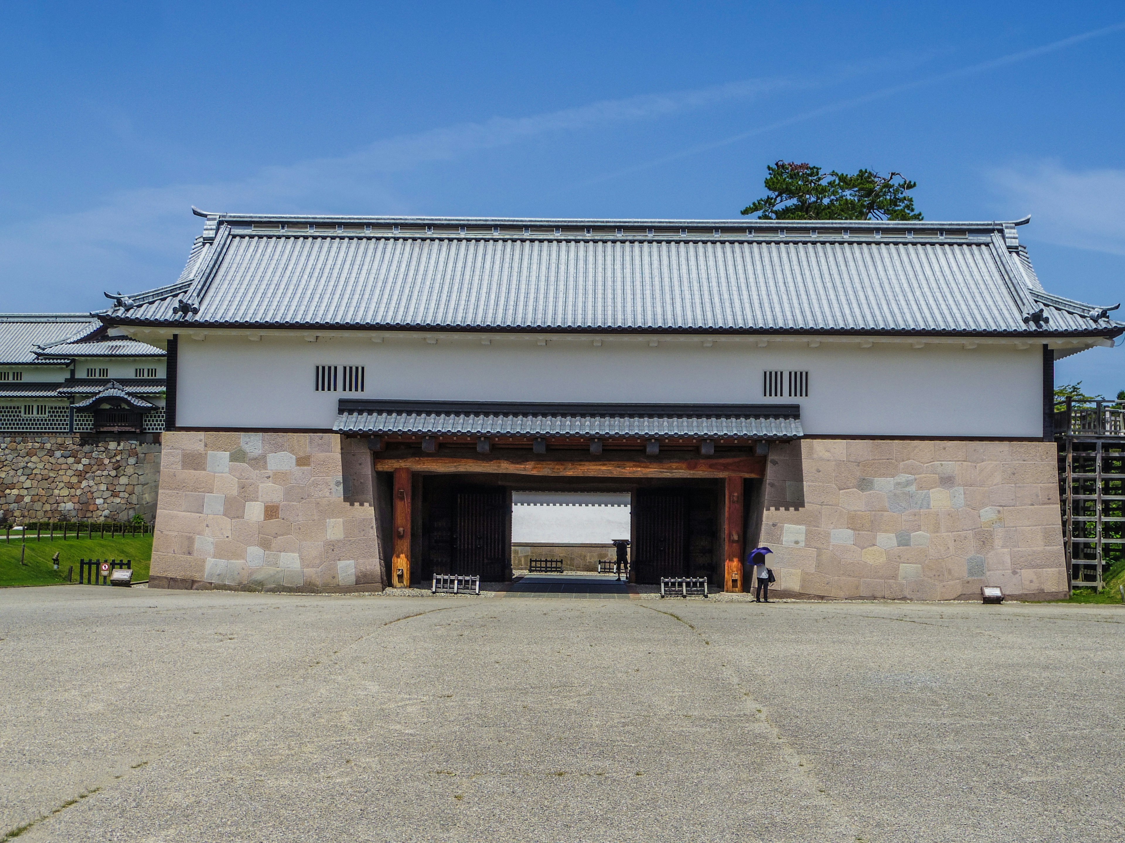 Traditional castle gate architecture with a blue sky background