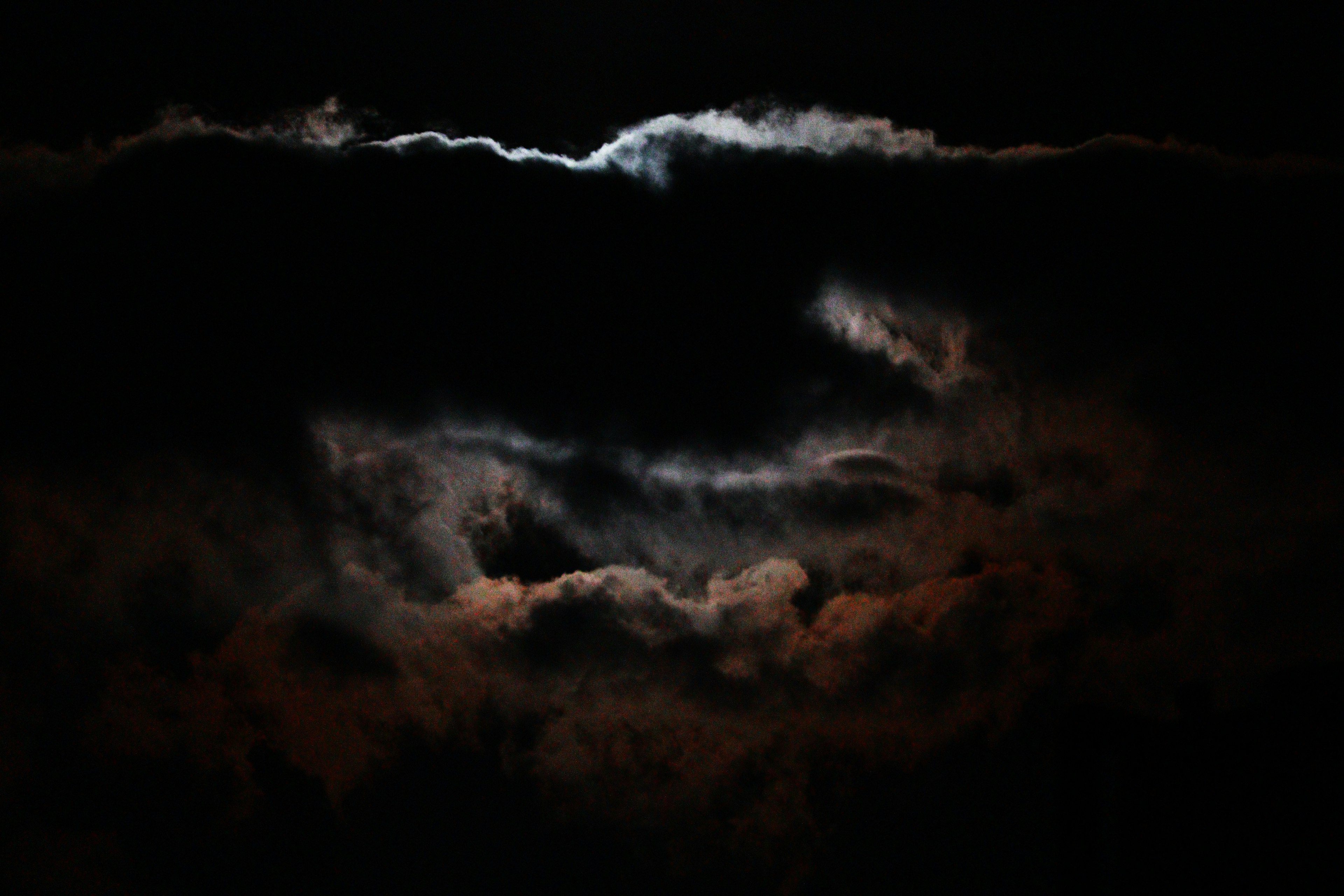 Ethereal view of moonlight peeking through dark clouds