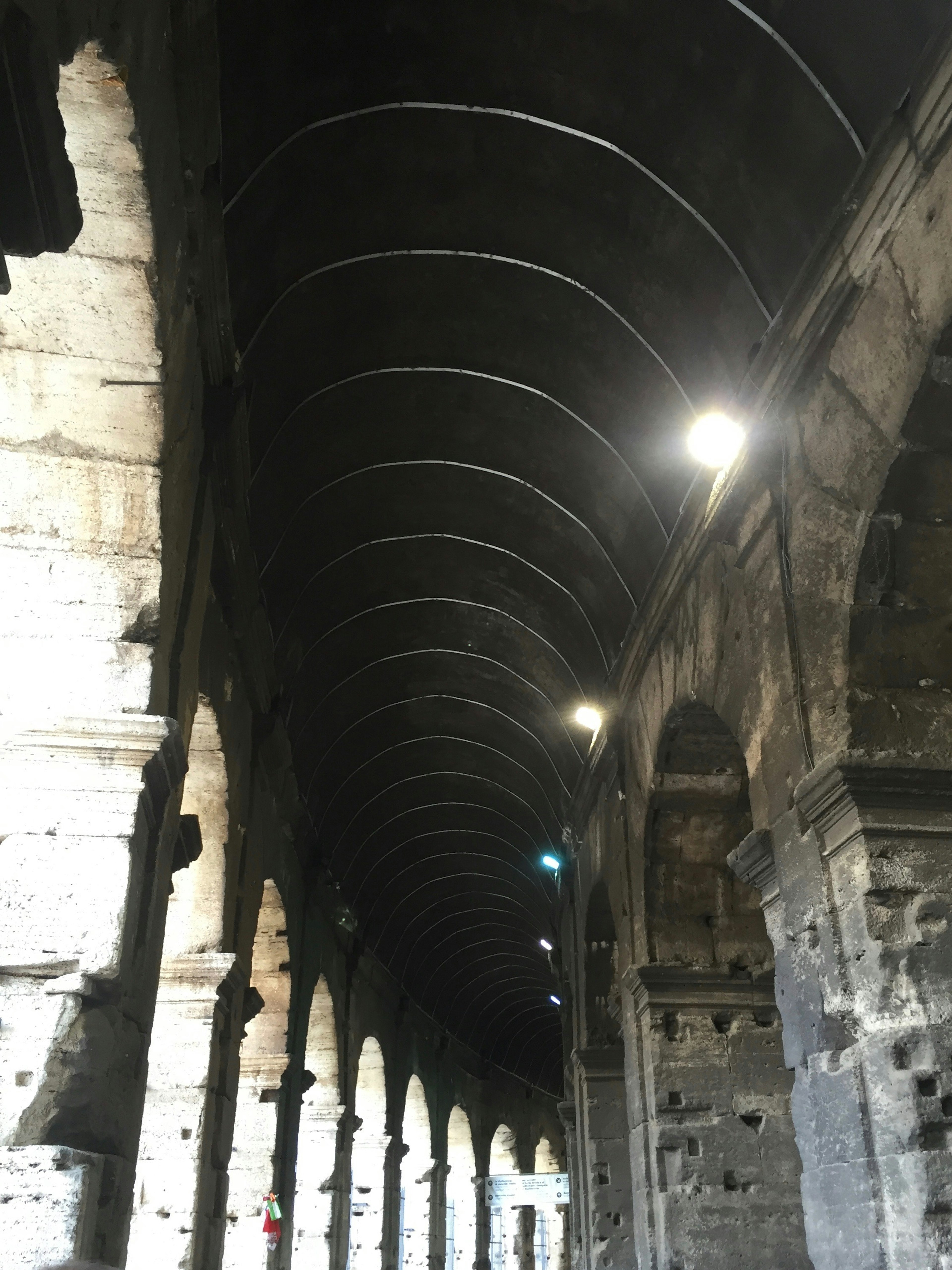 Interior view of an ancient stone arcade with an arched ceiling