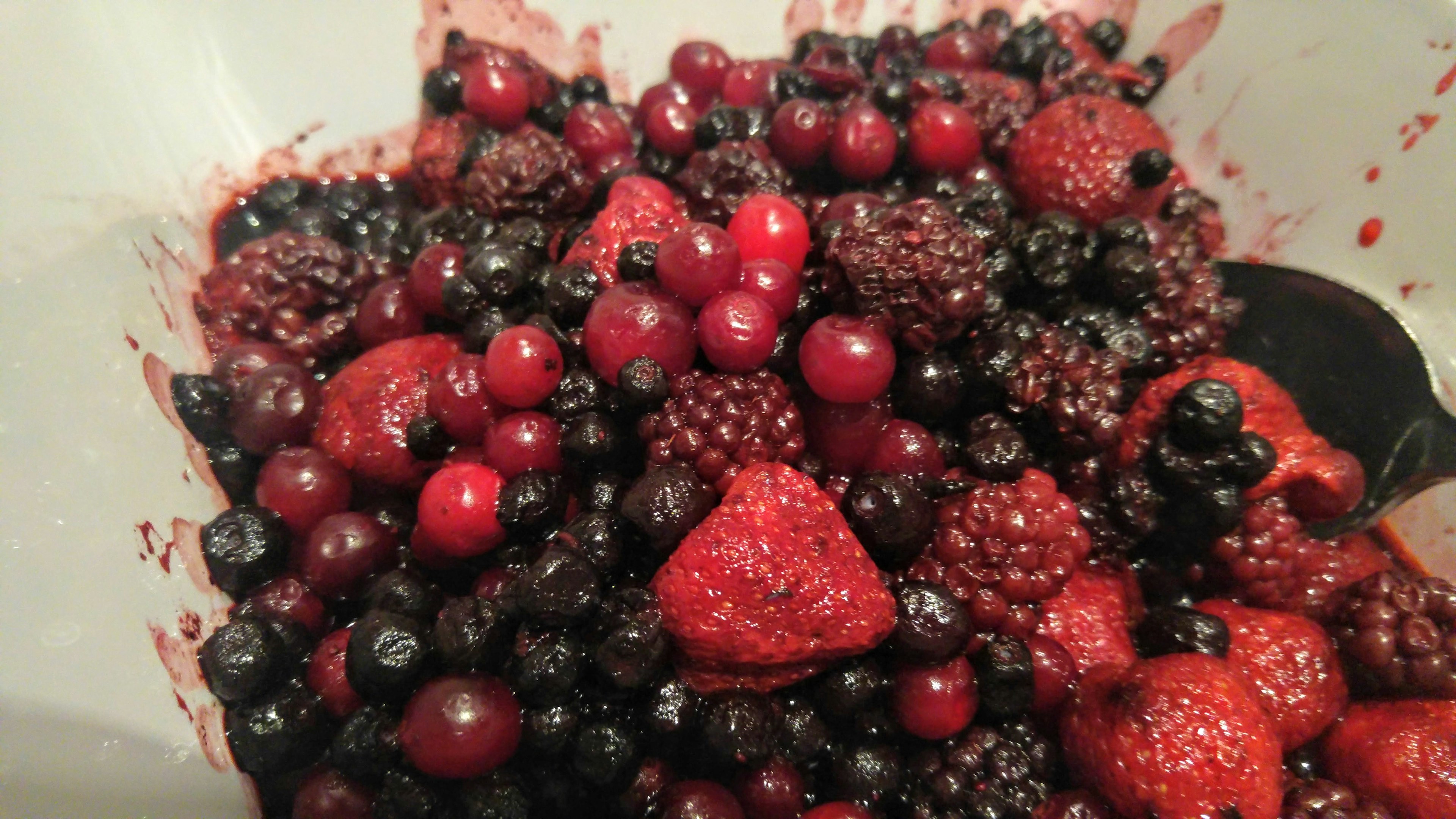 A colorful mix of fresh berries including strawberries, blackberries, and blueberries