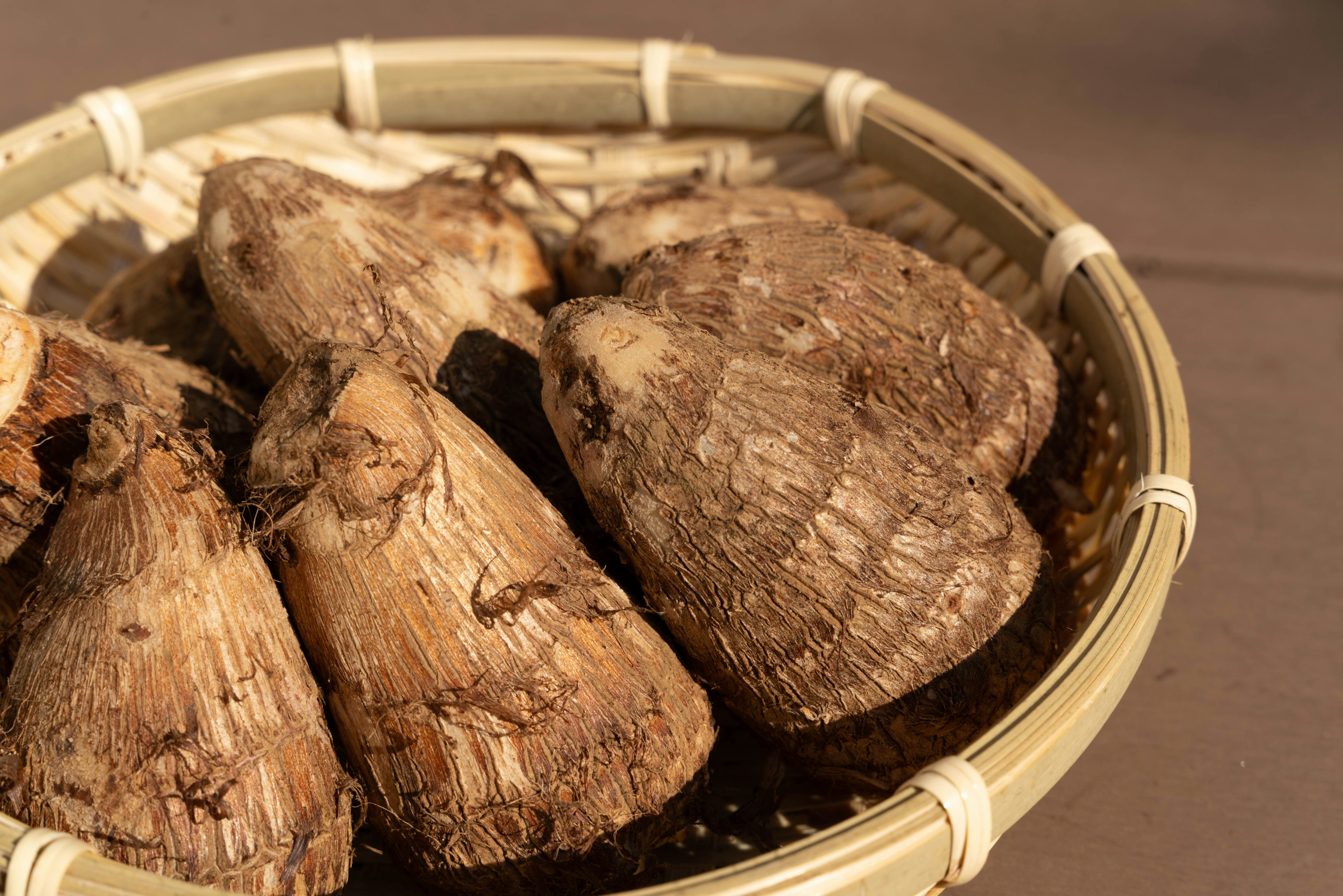 Several large root vegetables in a woven basket