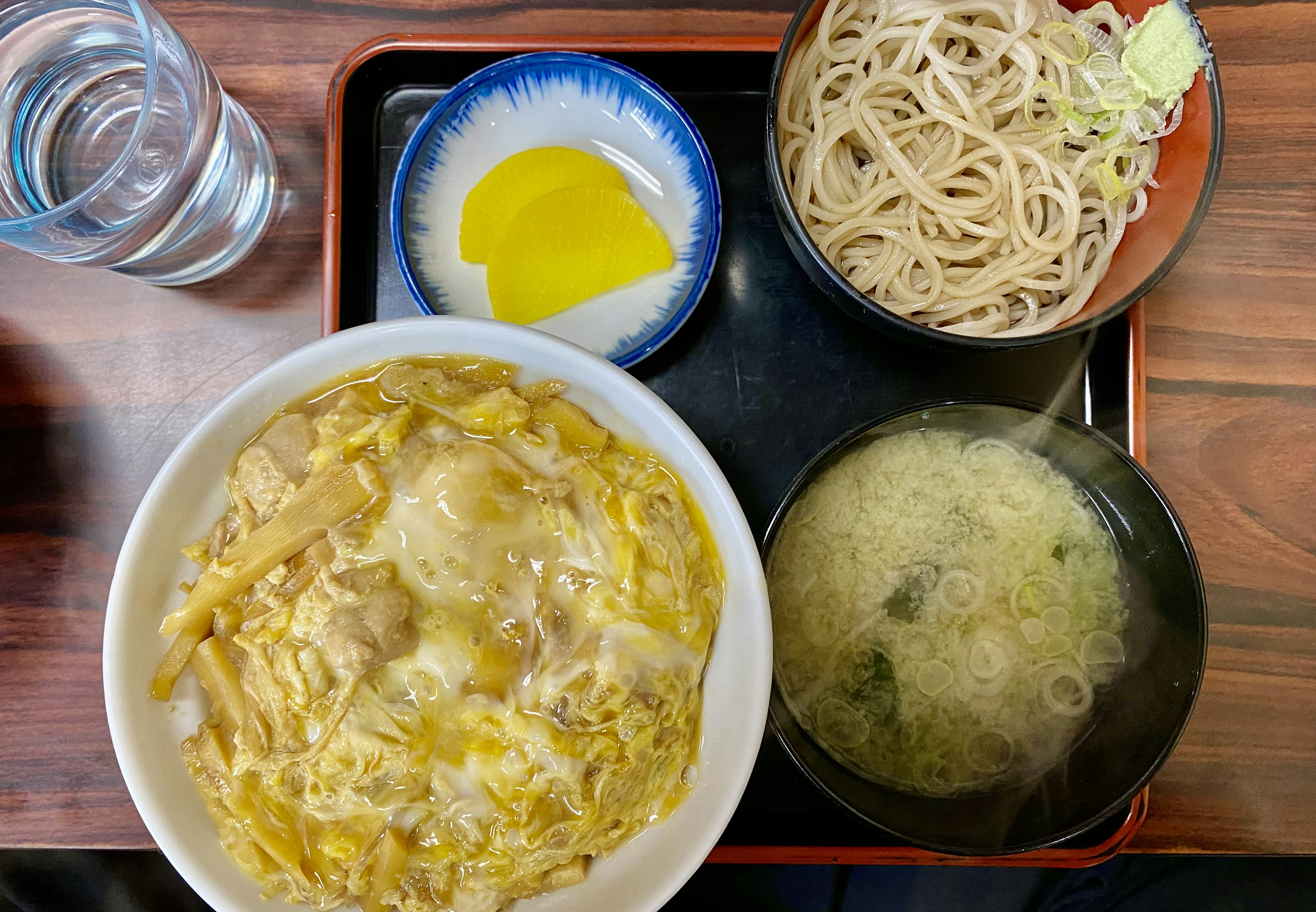 Ciotola di riso caldo con pollo e uovo servita con noodles soba zuppa di miso e sottaceti