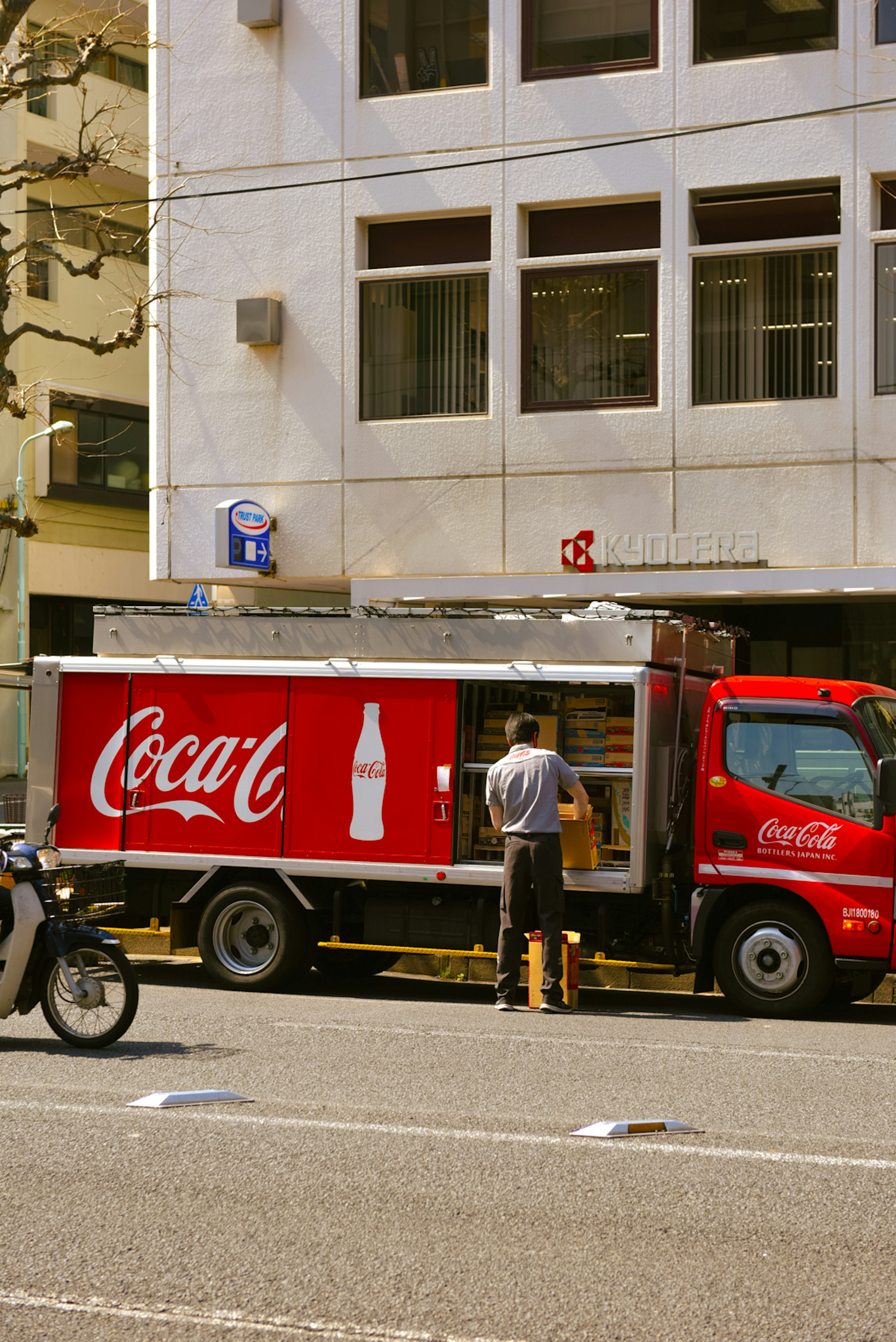 Coca-Cola truck unloading goods on a city street