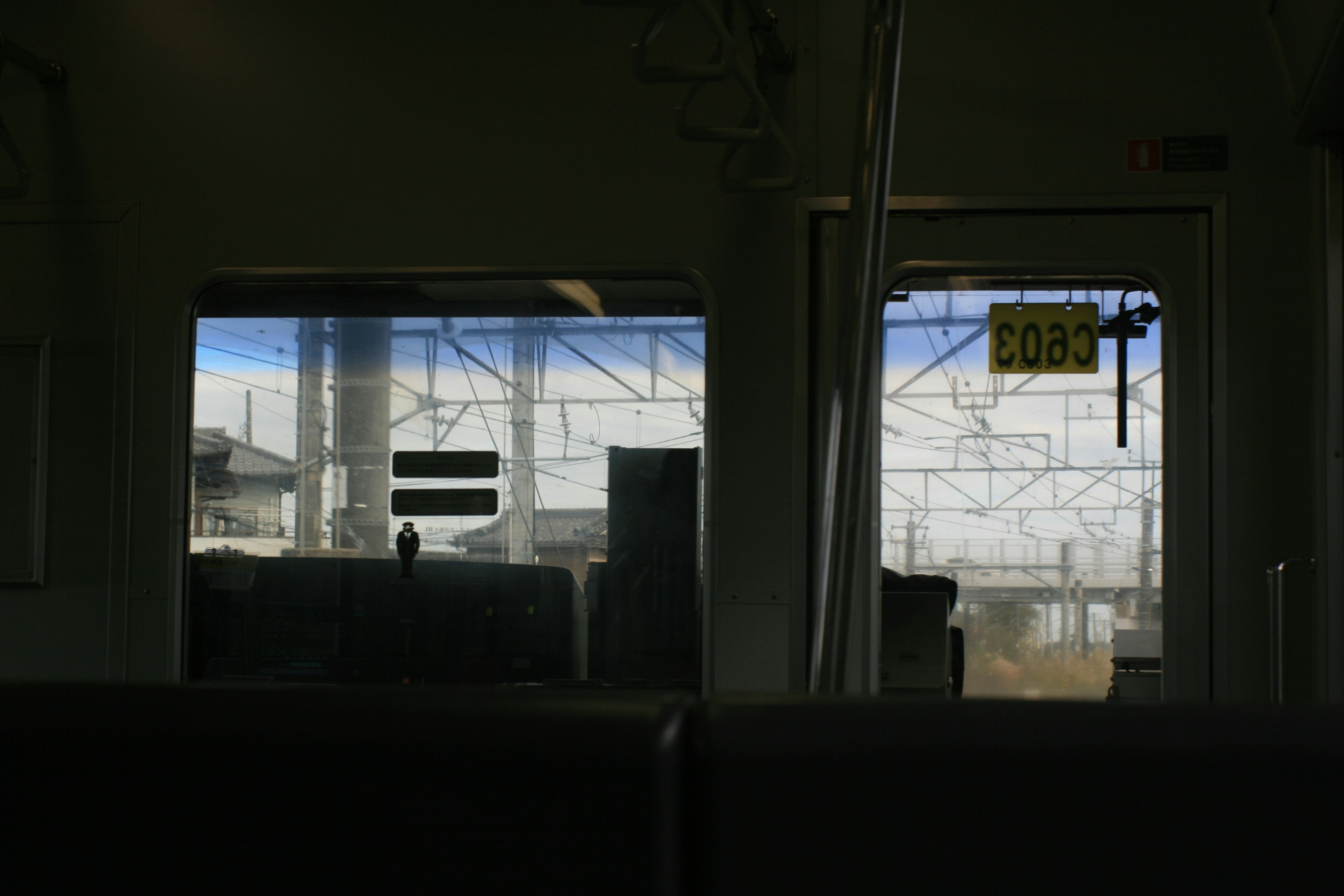 View from a train window showing surrounding structures and railway tracks