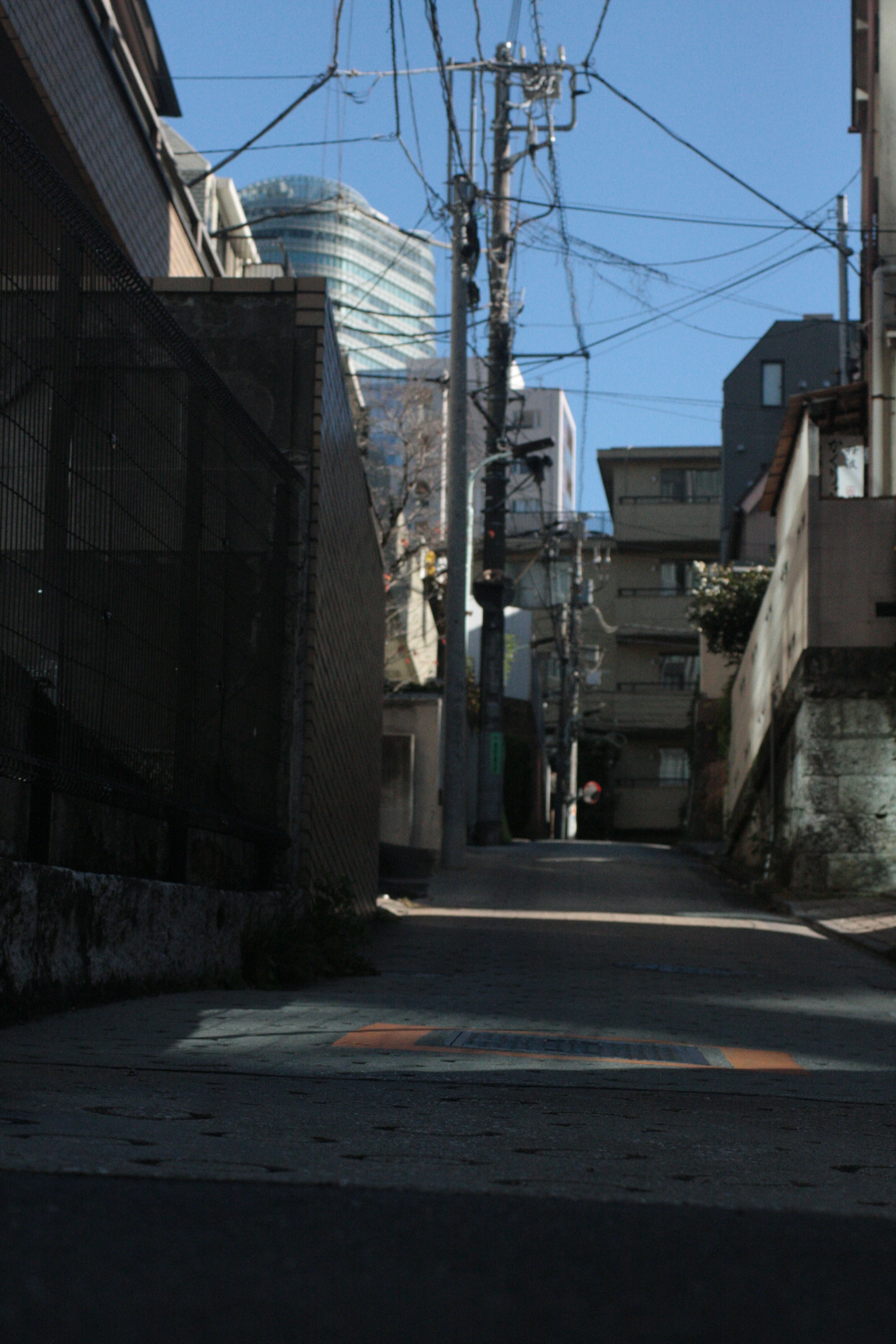 Narrow alley with urban buildings and power lines