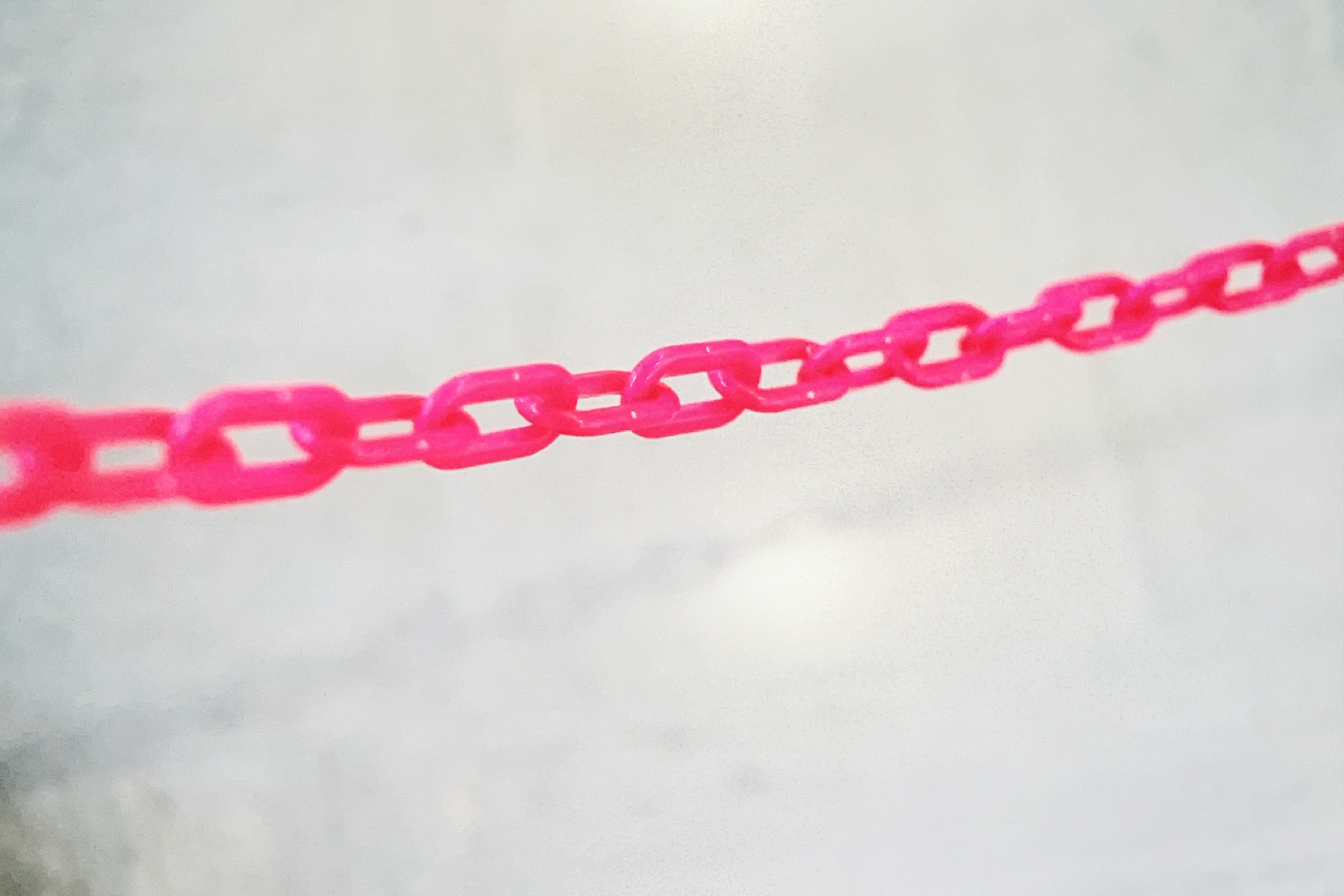 A vibrant pink chain extending along the floor