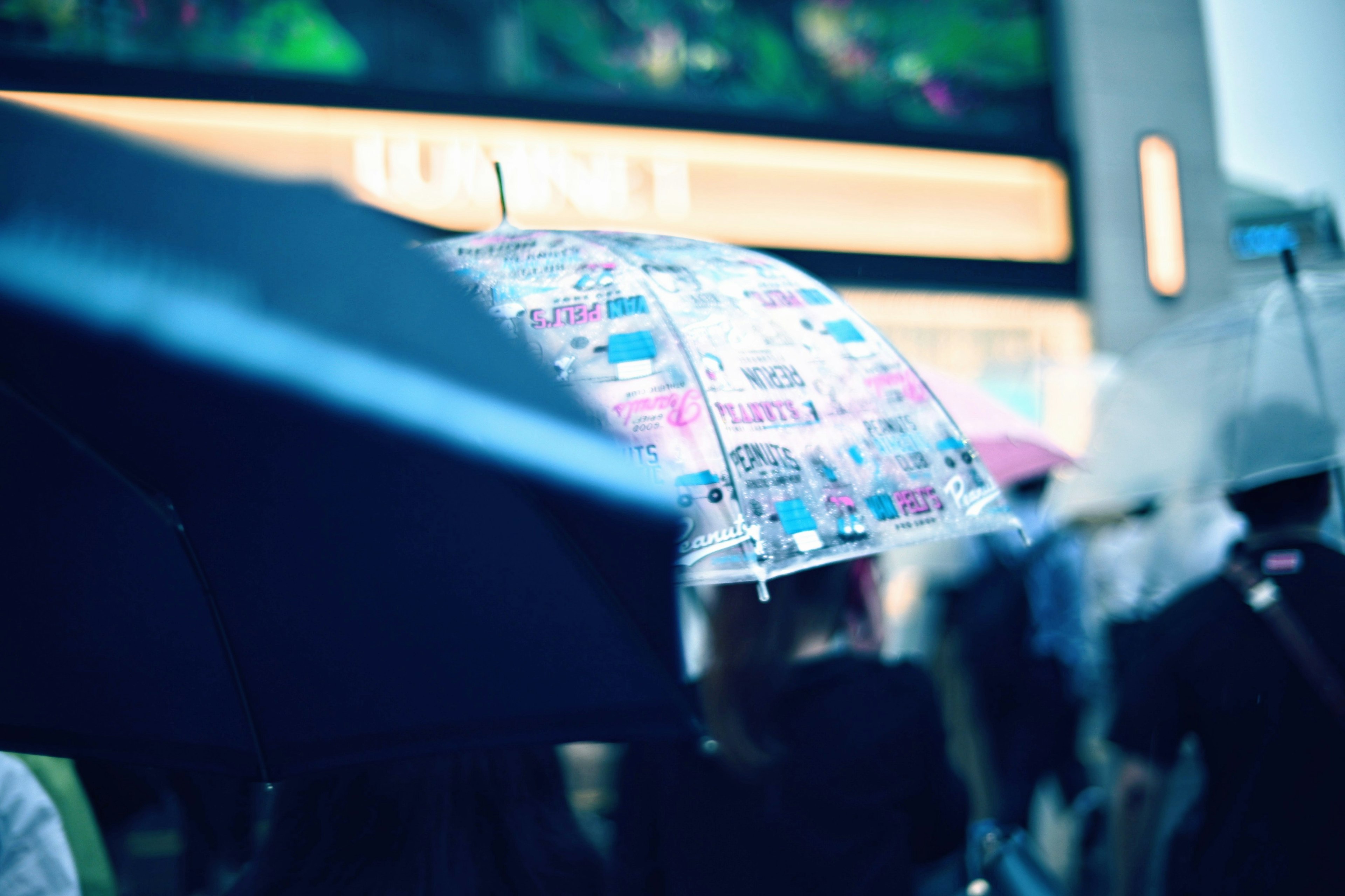 A bustling city scene with people holding colorful umbrellas