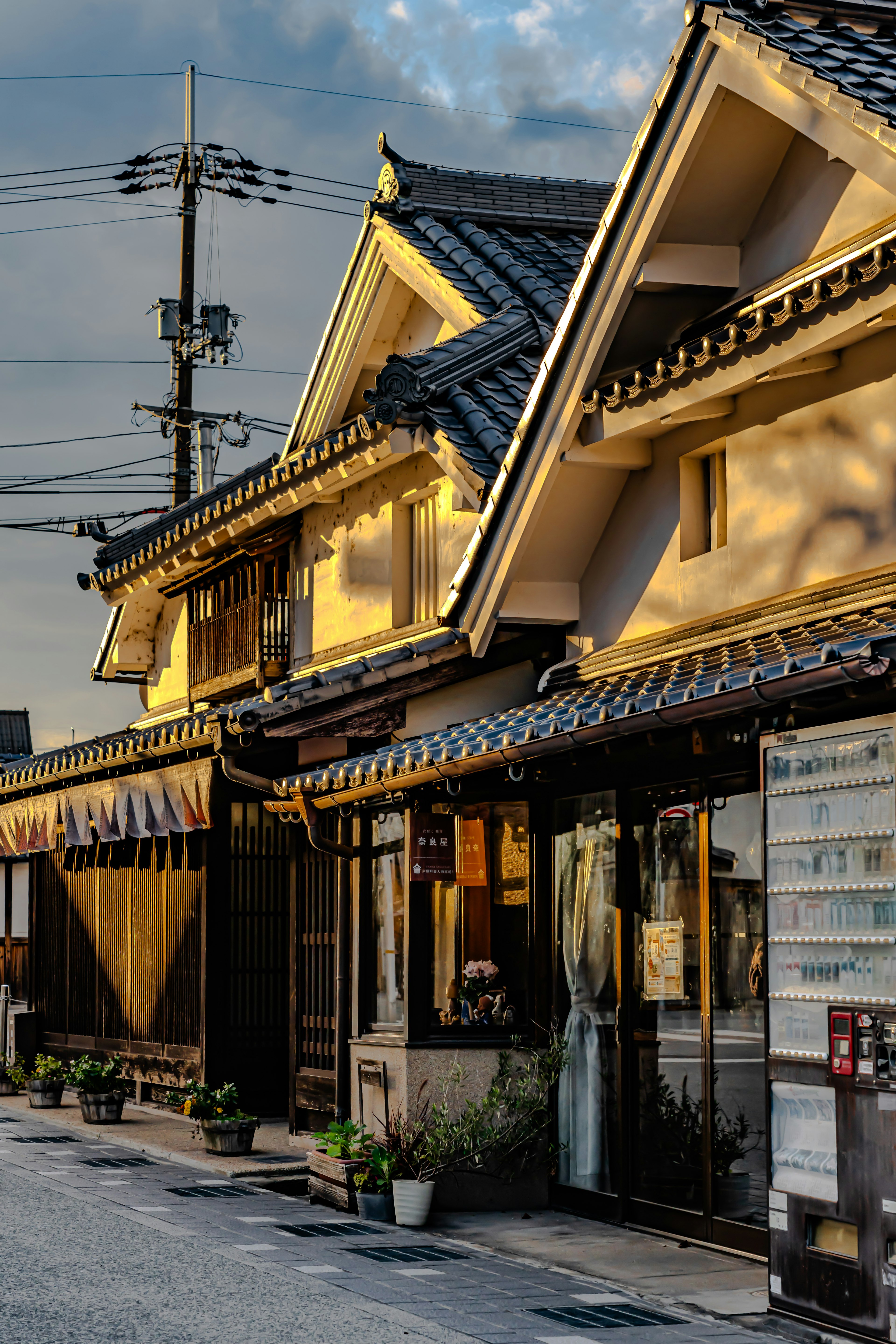 Traditional Japanese street scene with wooden houses bathed in soft evening light