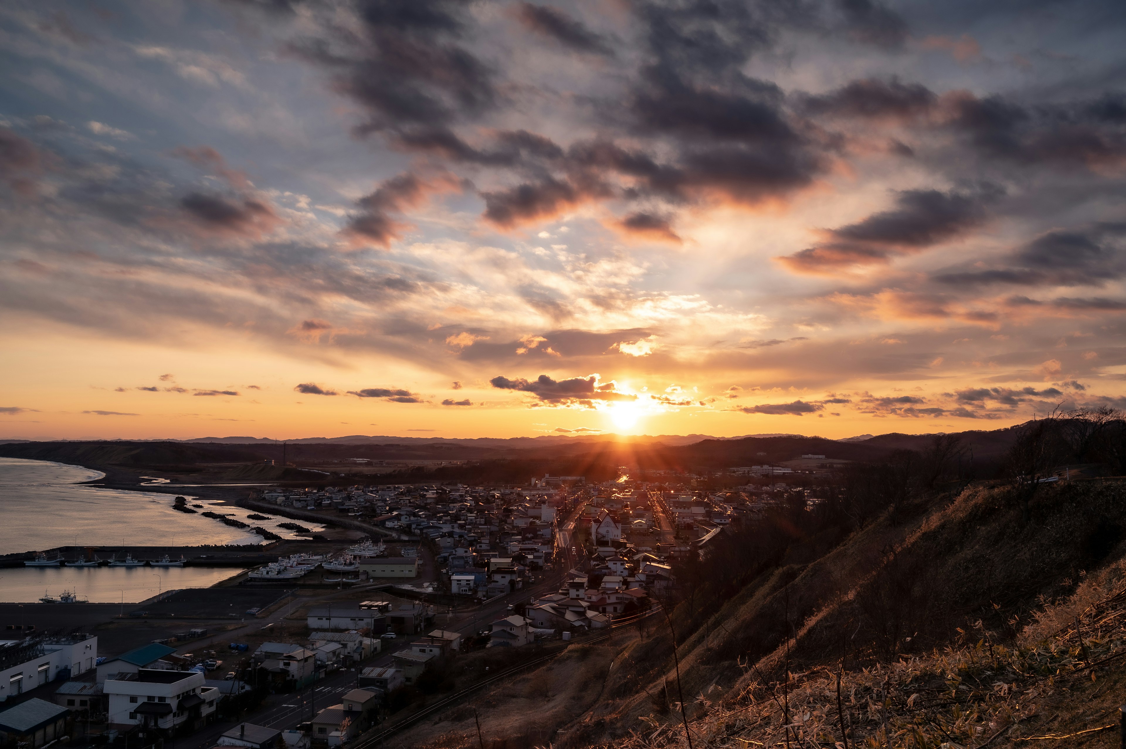 Beautiful sunset illuminating the sea and town landscape