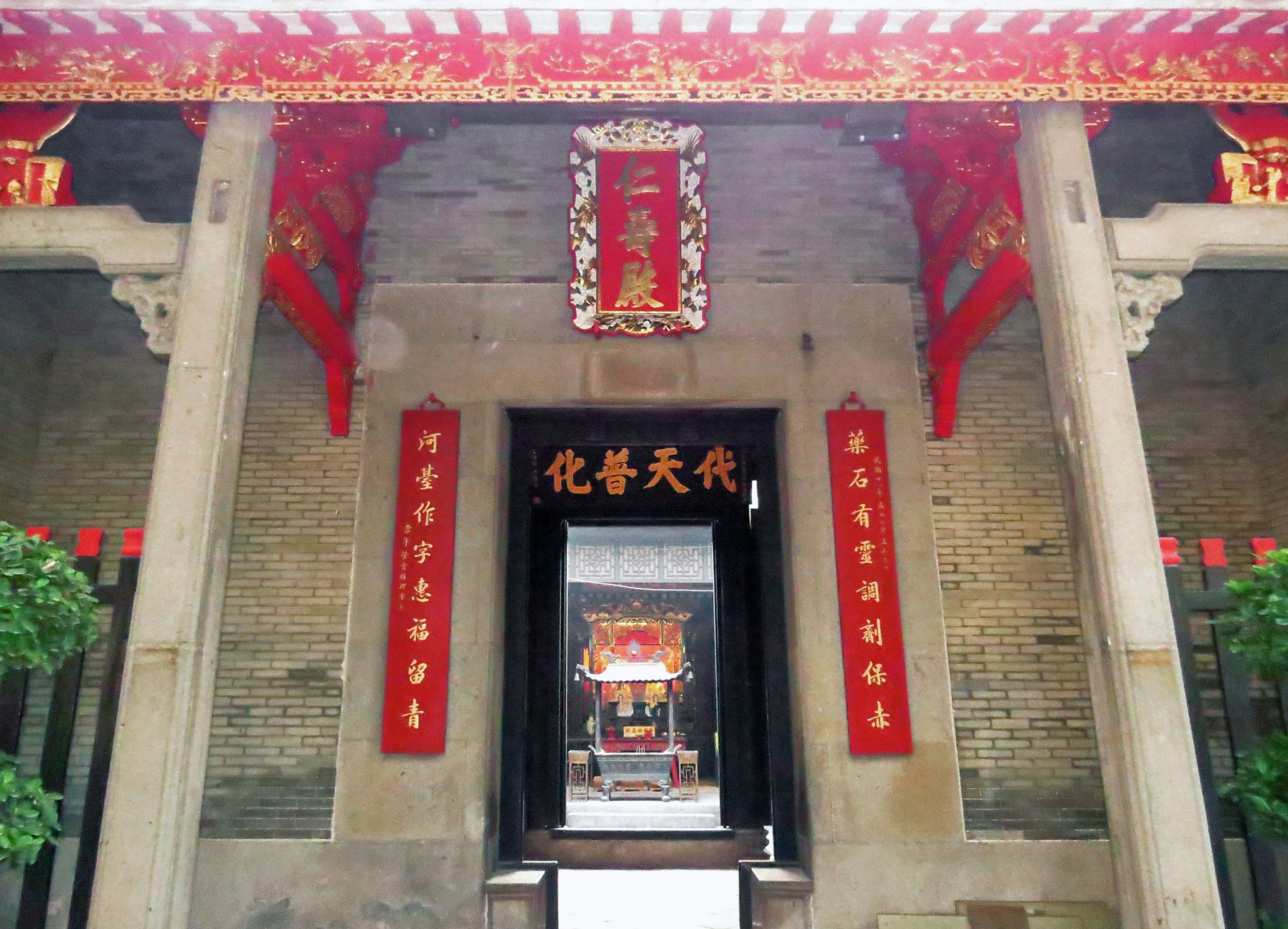 Entrance of a temple with red decorations and traditional architecture