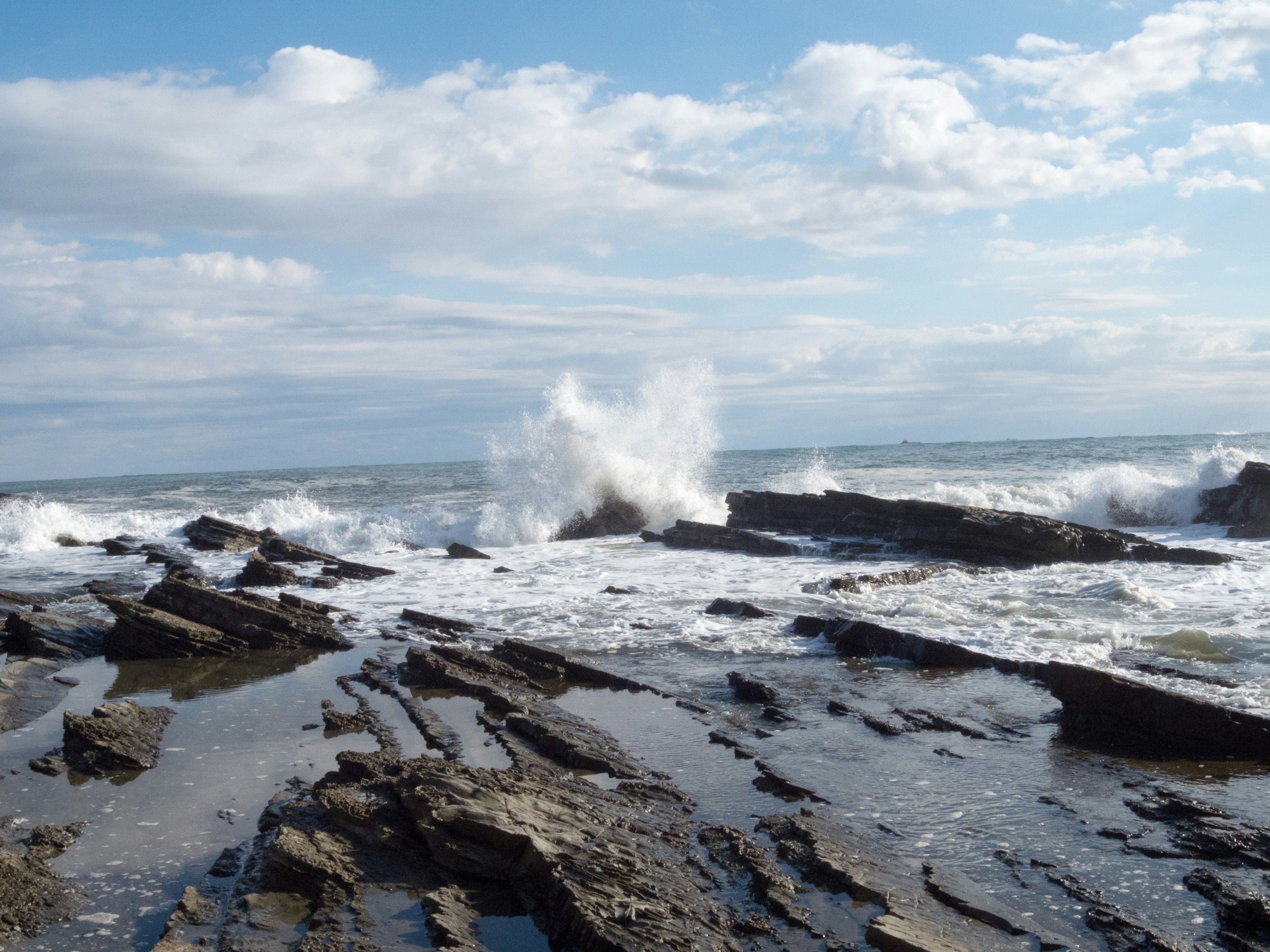 Coastal scene with waves crashing against rocks