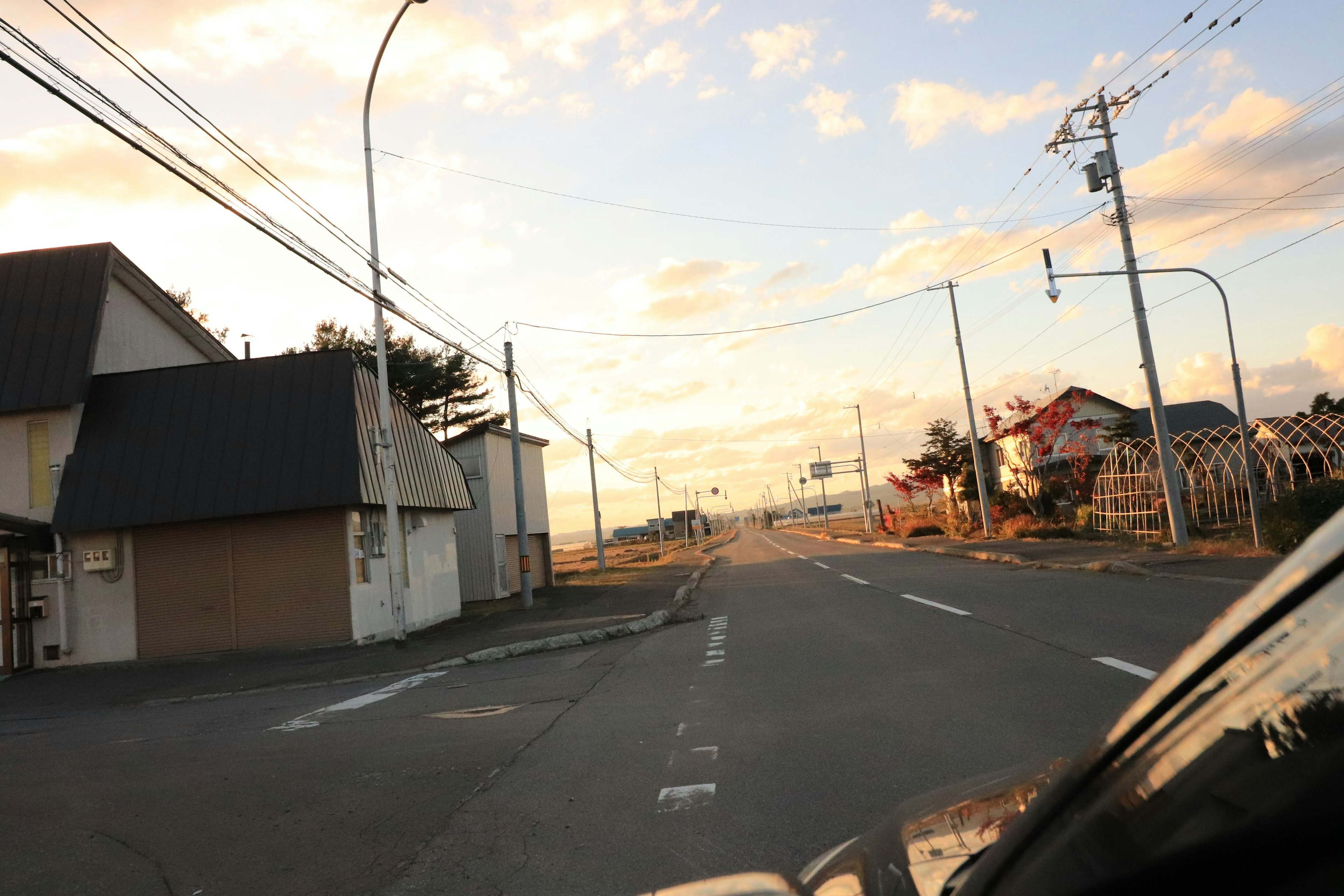 Scenic view of a quiet road and residential area during sunrise