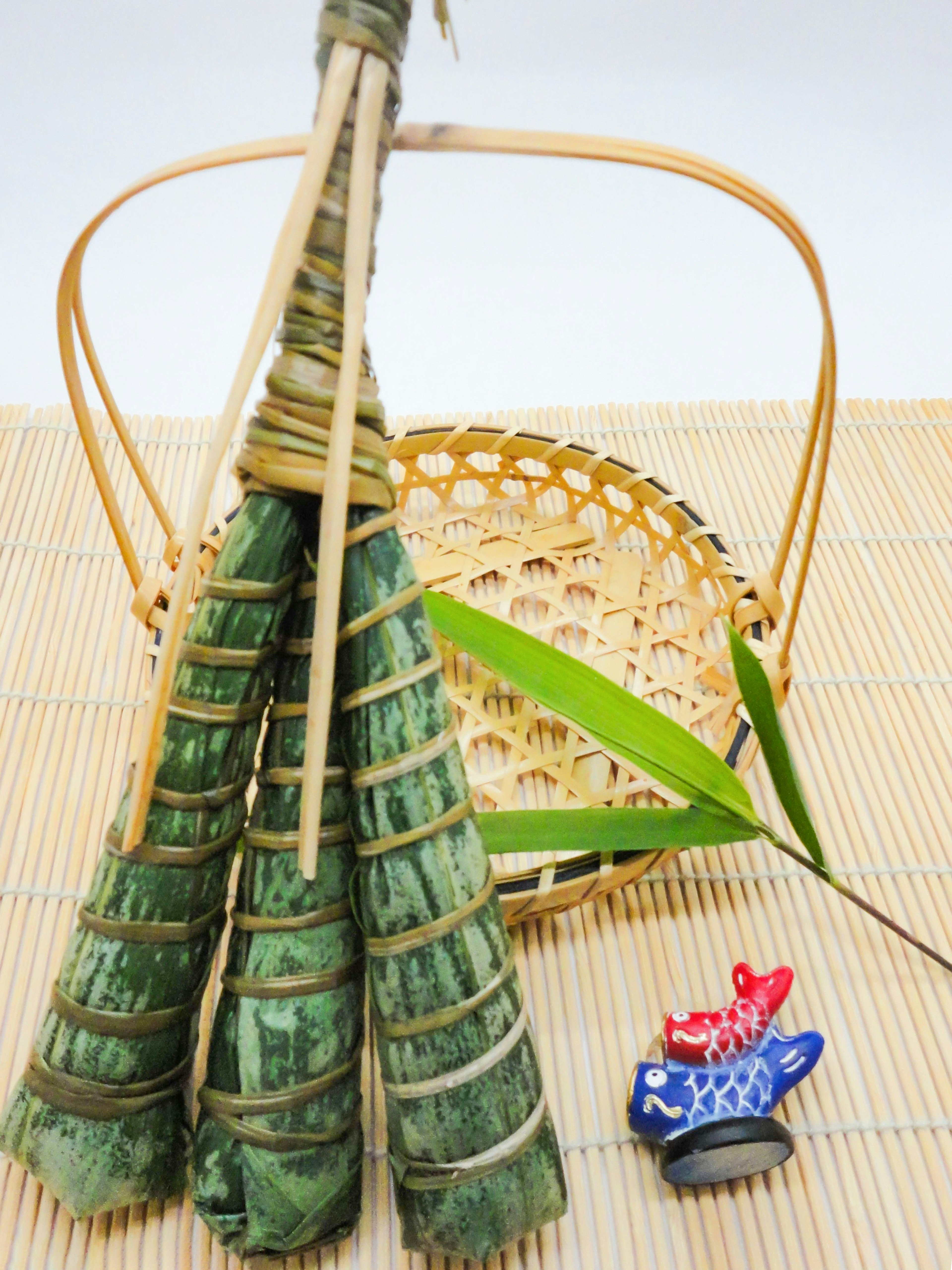 Traditional food wrapped in green leaves with a bamboo basket