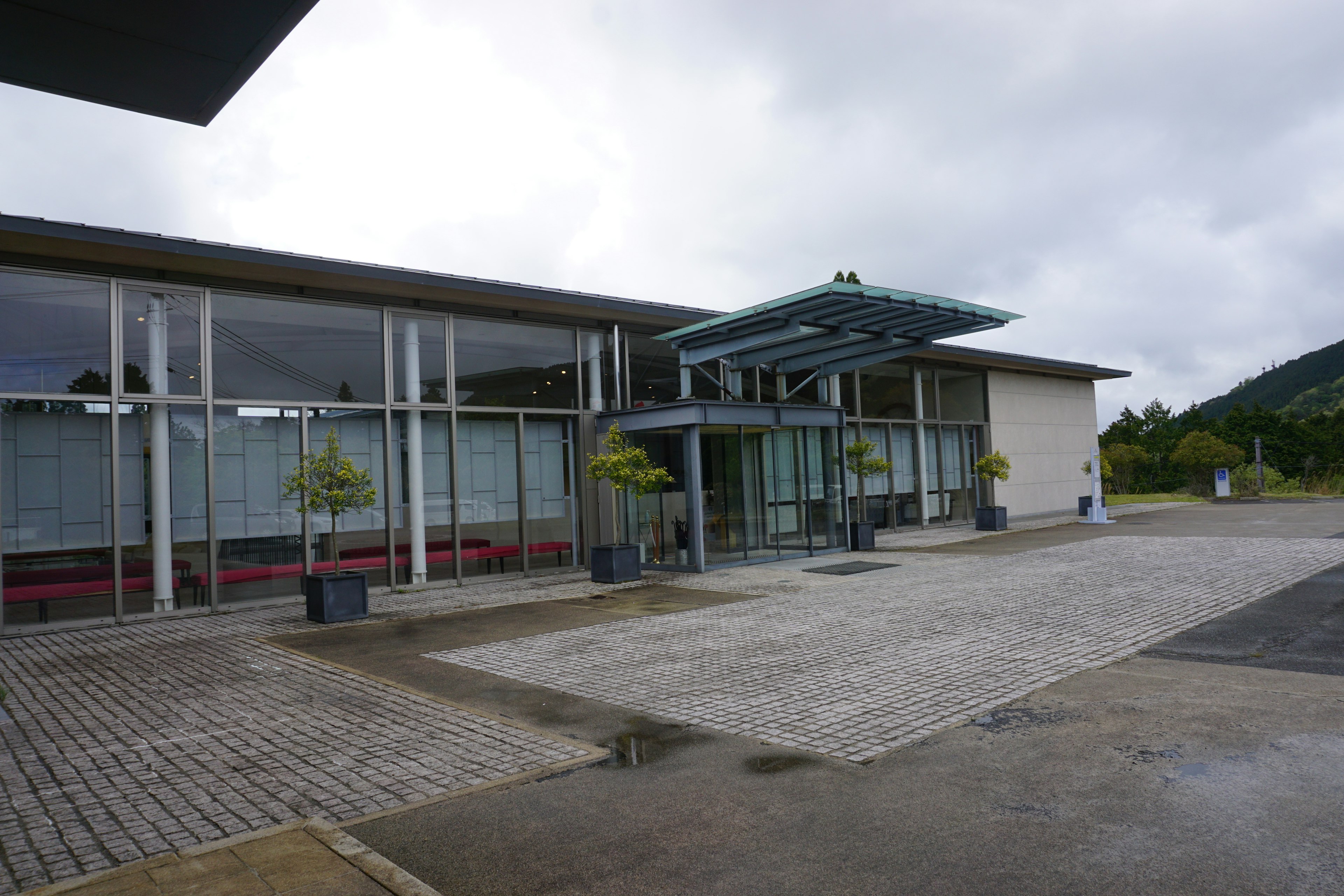 Modern building exterior featuring a large glass entrance and canopy