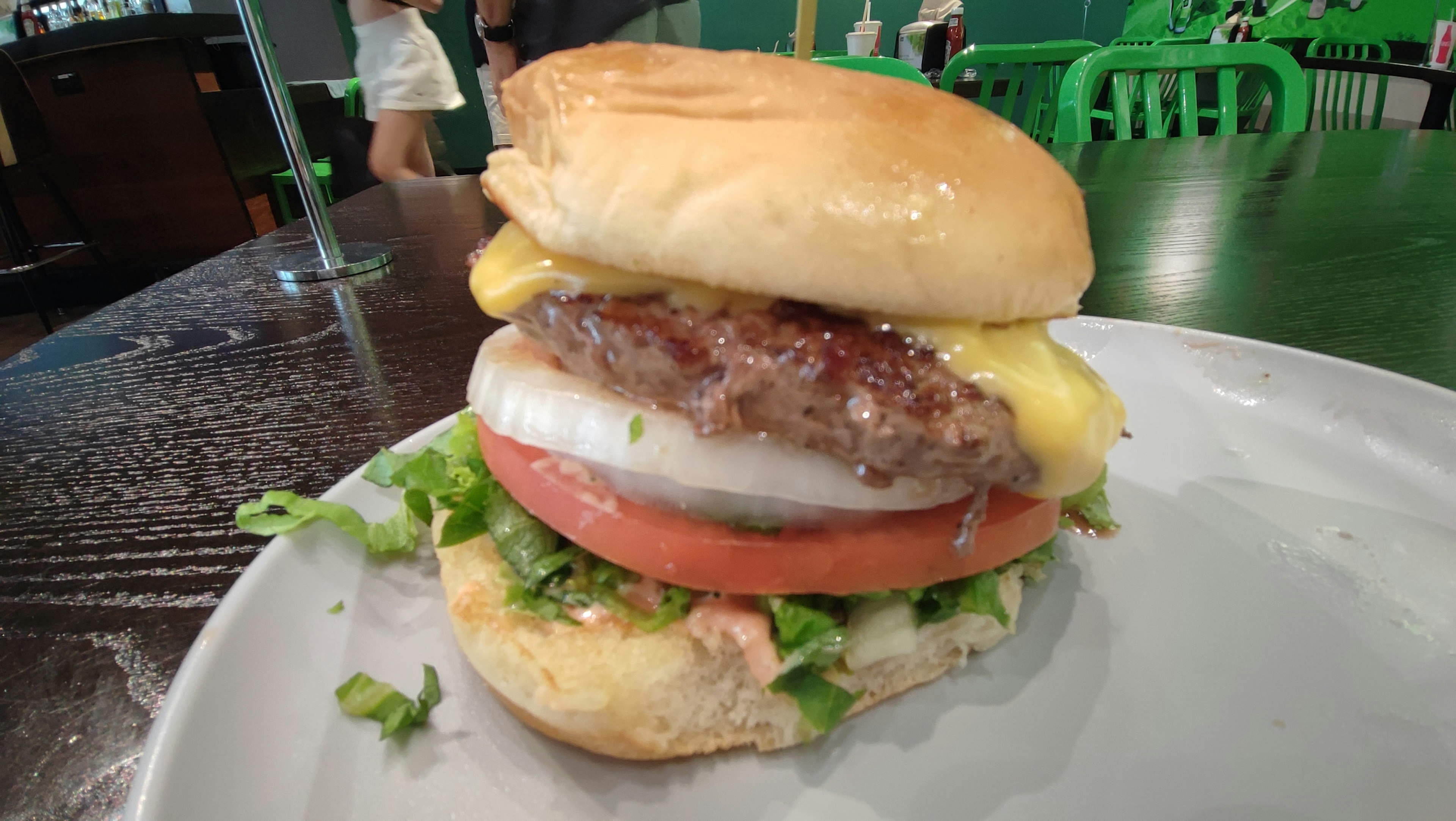 A hearty hamburger with a juicy patty and cheese layered with fresh lettuce and tomato