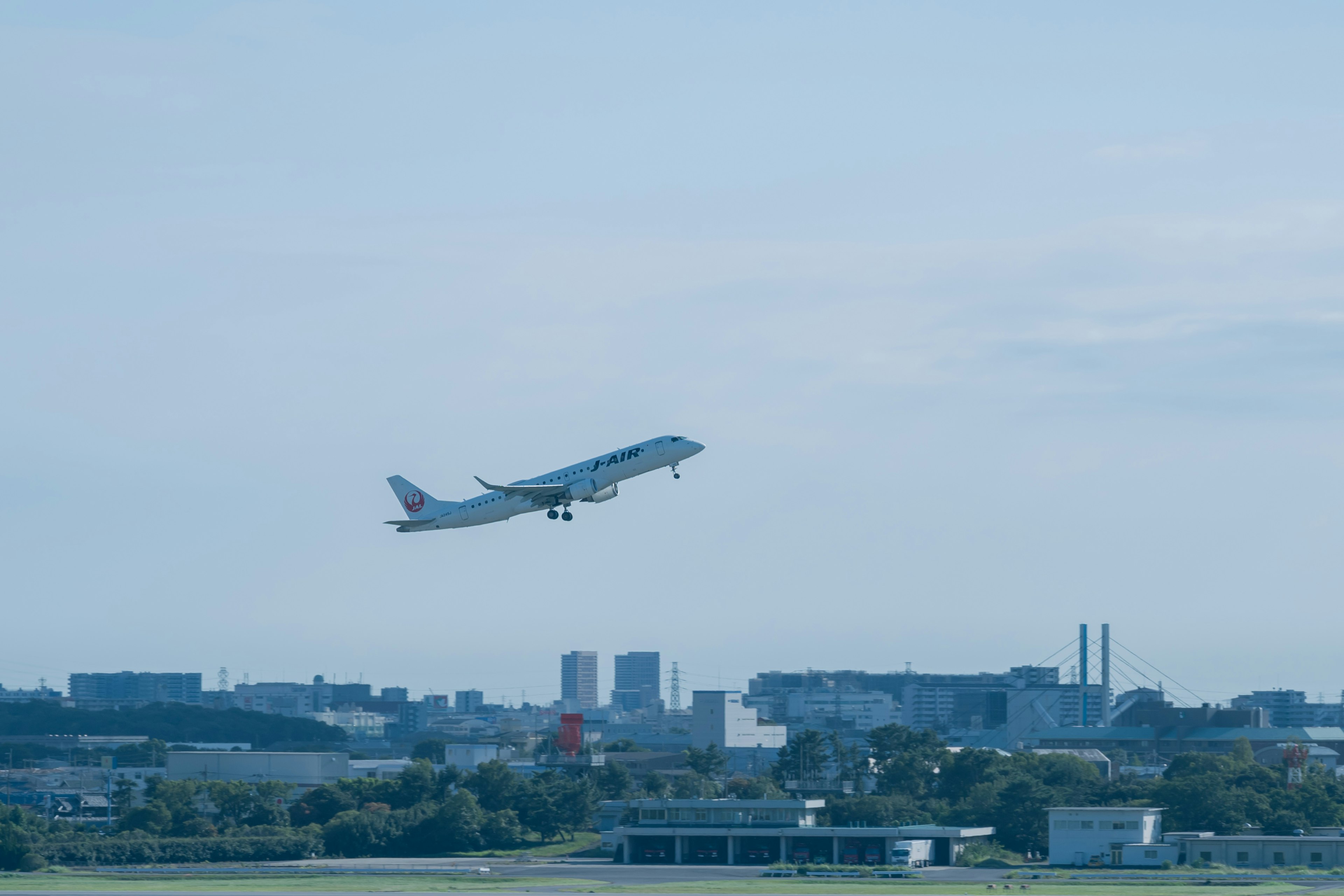 An airplane taking off into a clear blue sky