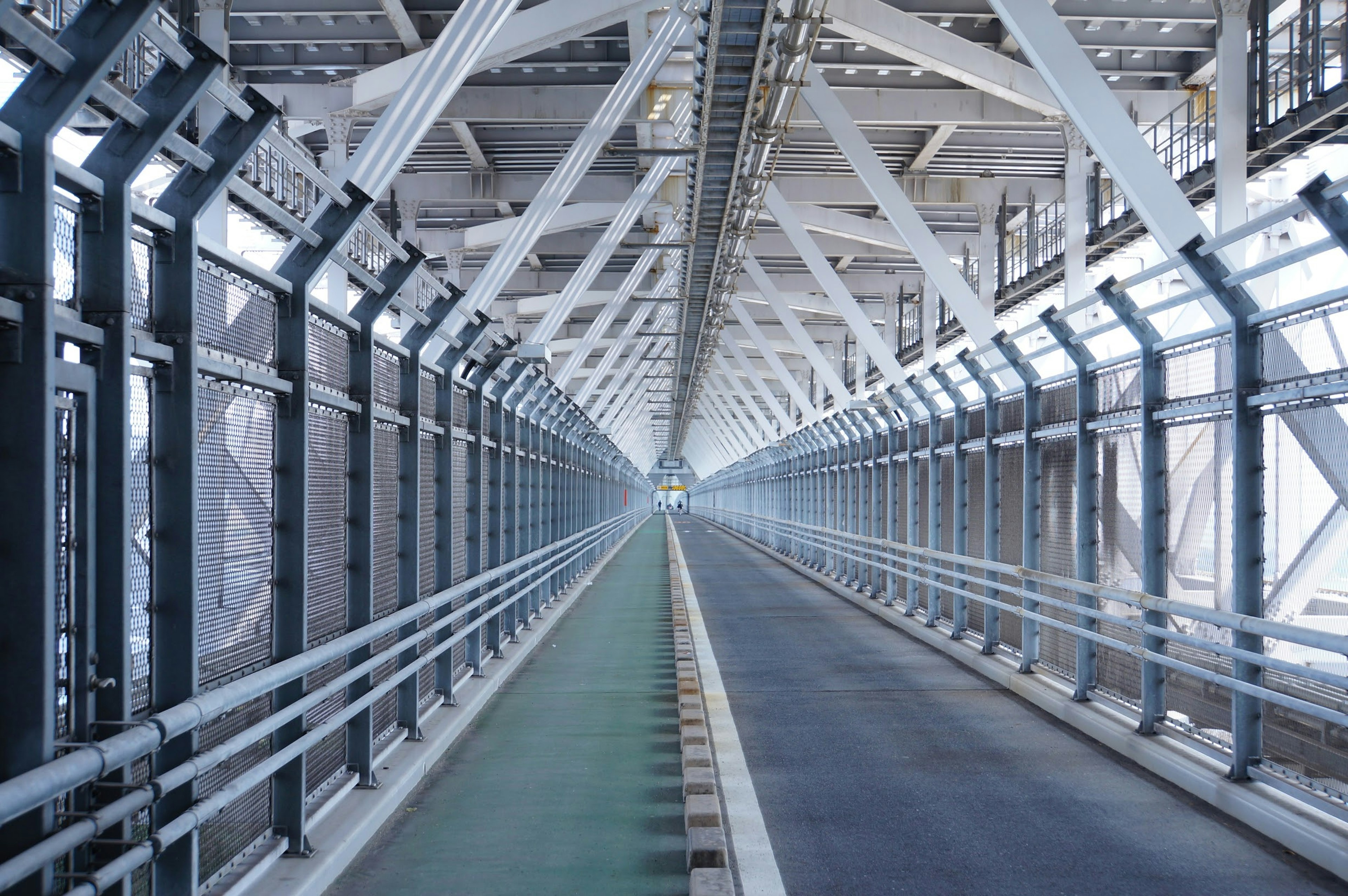 Interior view of a metal bridge showcasing linear pathways and structural beams