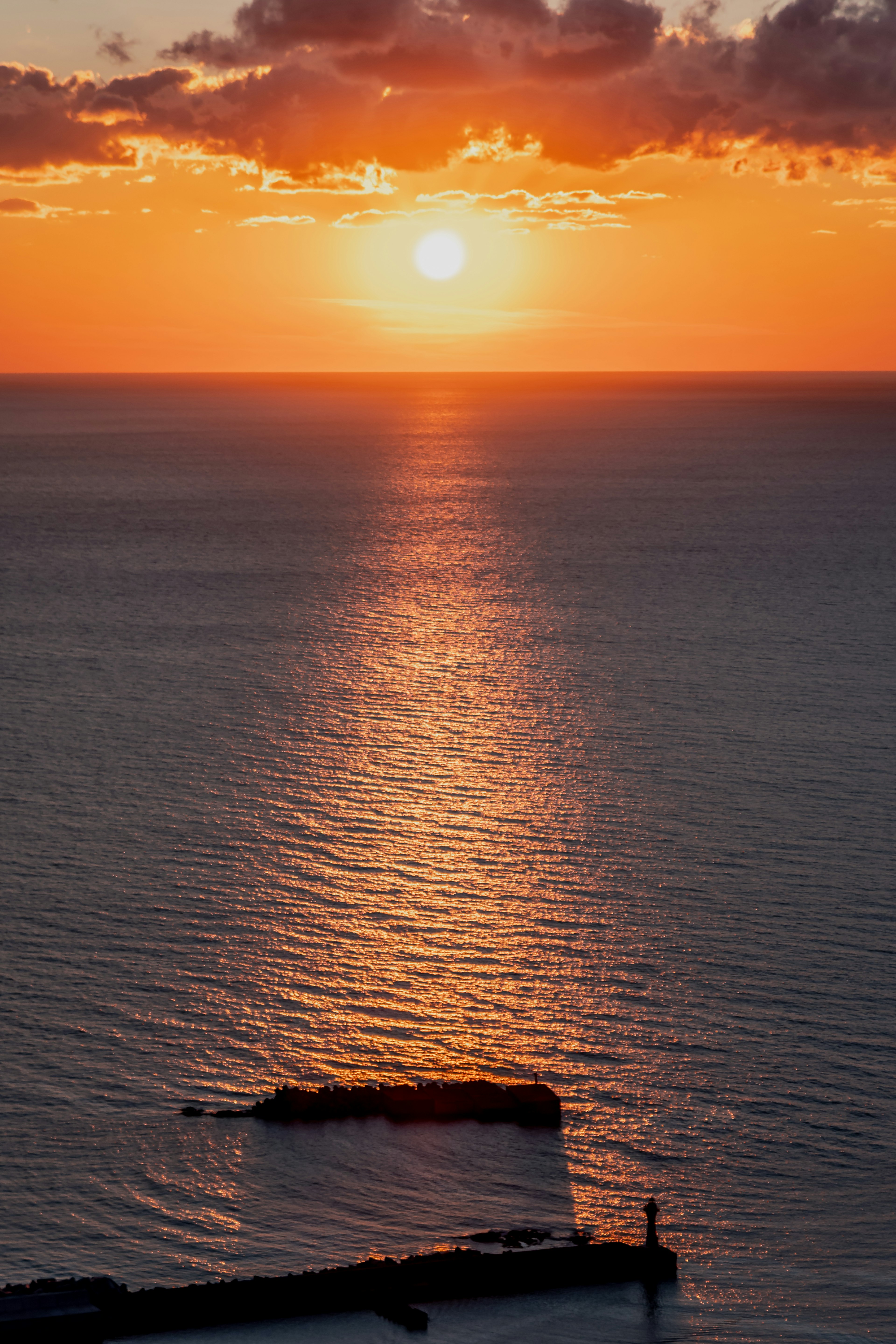 A beautiful sunset over the ocean with calm water