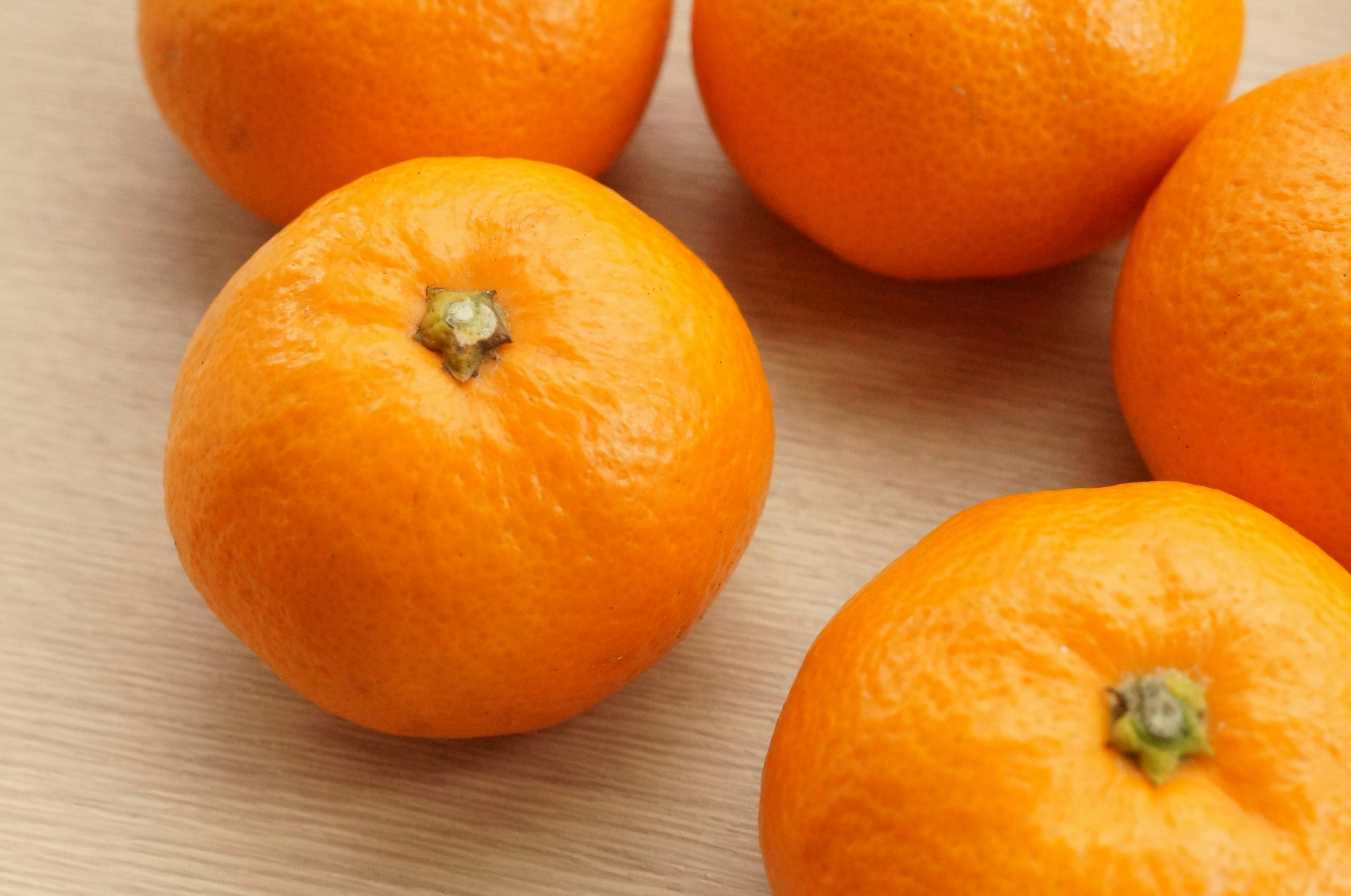 Vibrant oranges placed on a wooden table