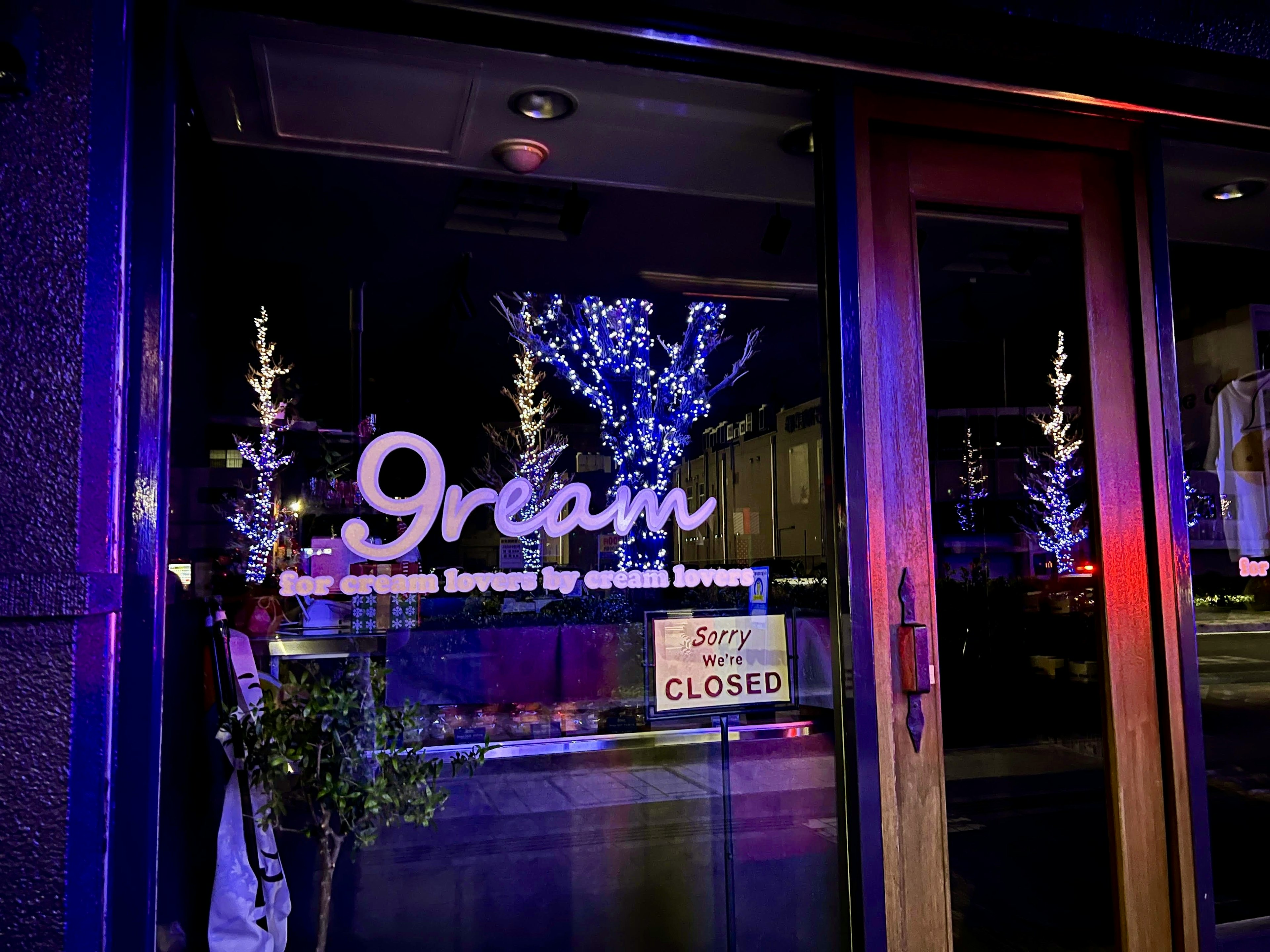 Exterior of closed ice cream shop featuring 9ream sign and decorated trees