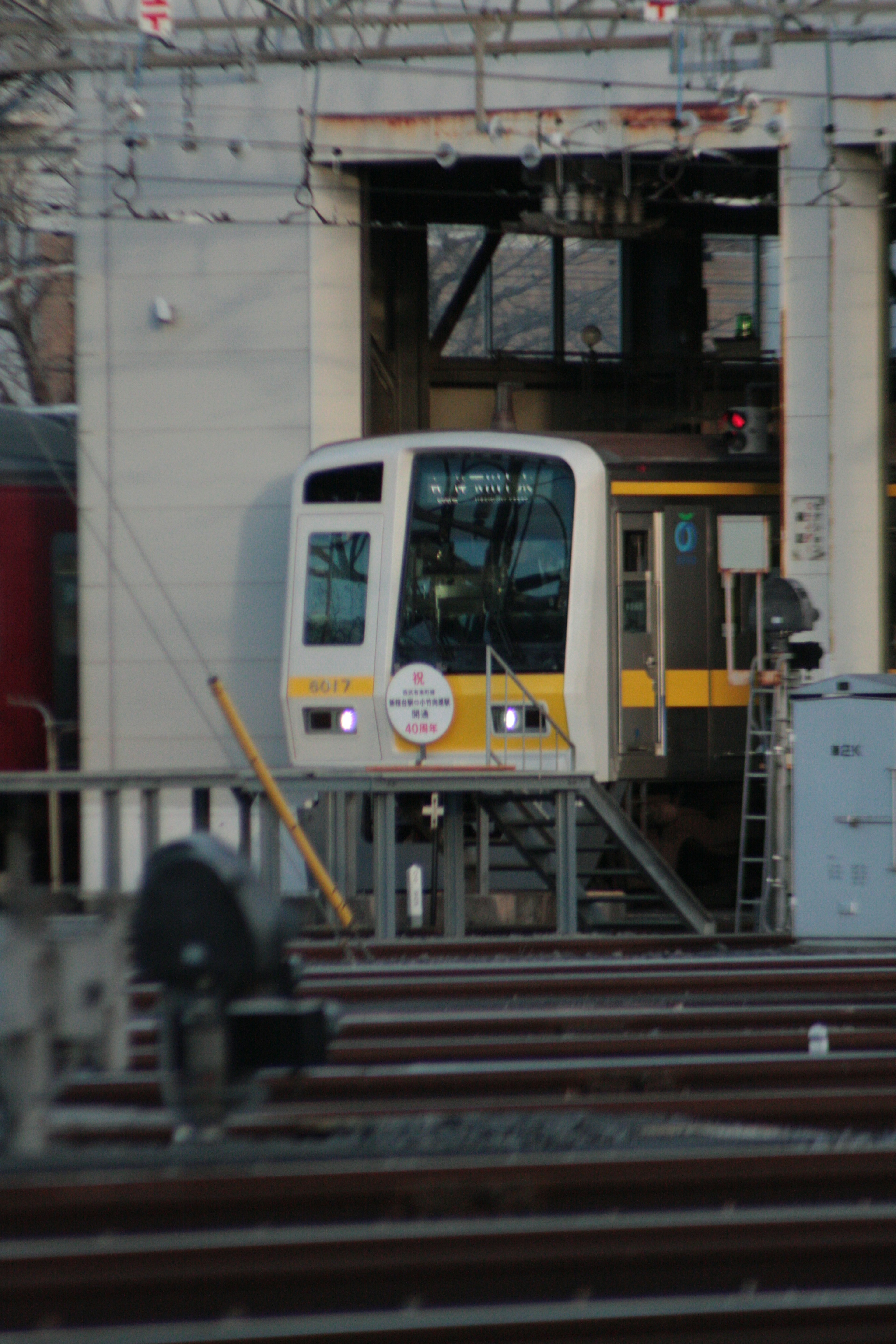 Train at a station with visible tracks and platform