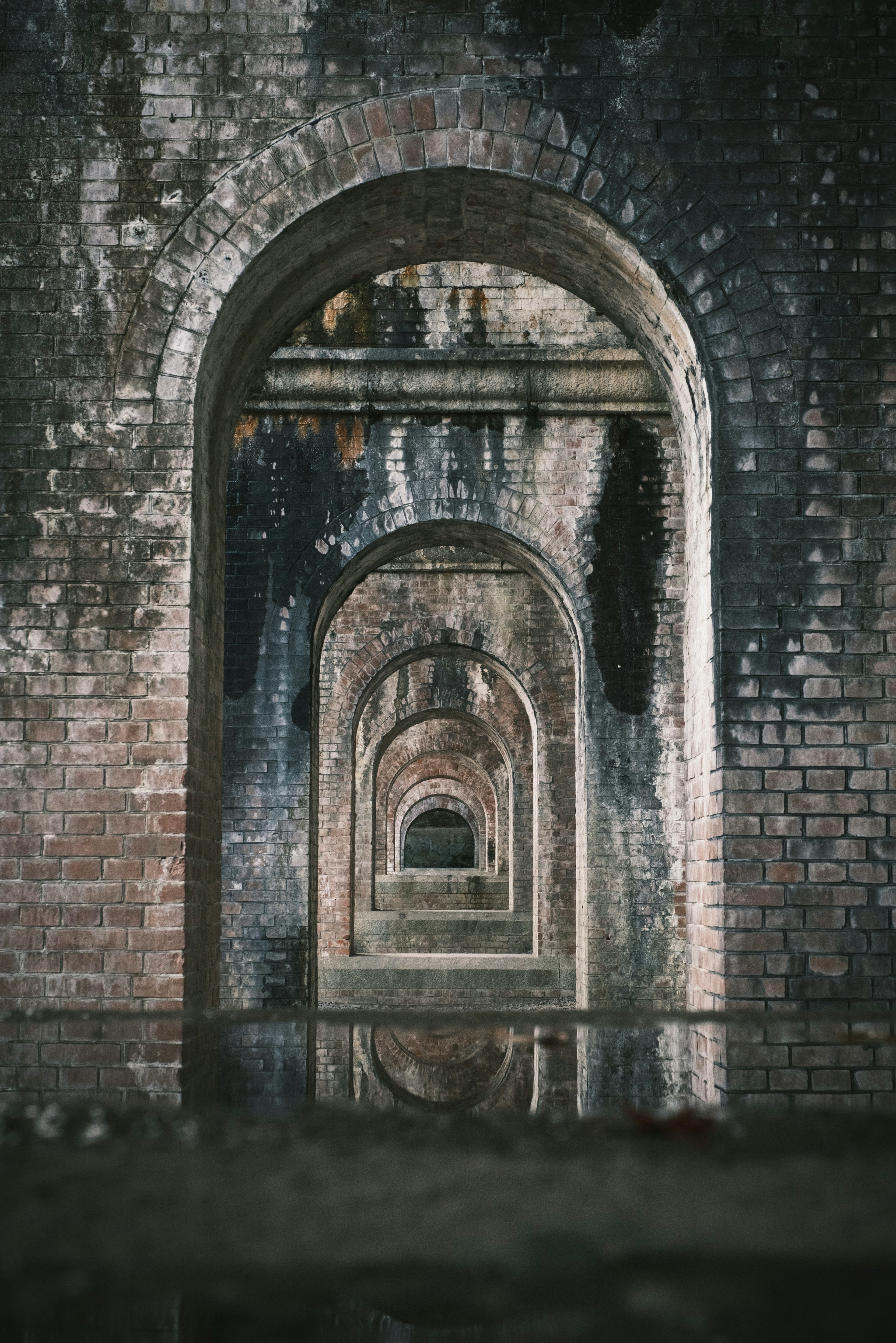 Interior view of a tunnel with multiple arched brick structures