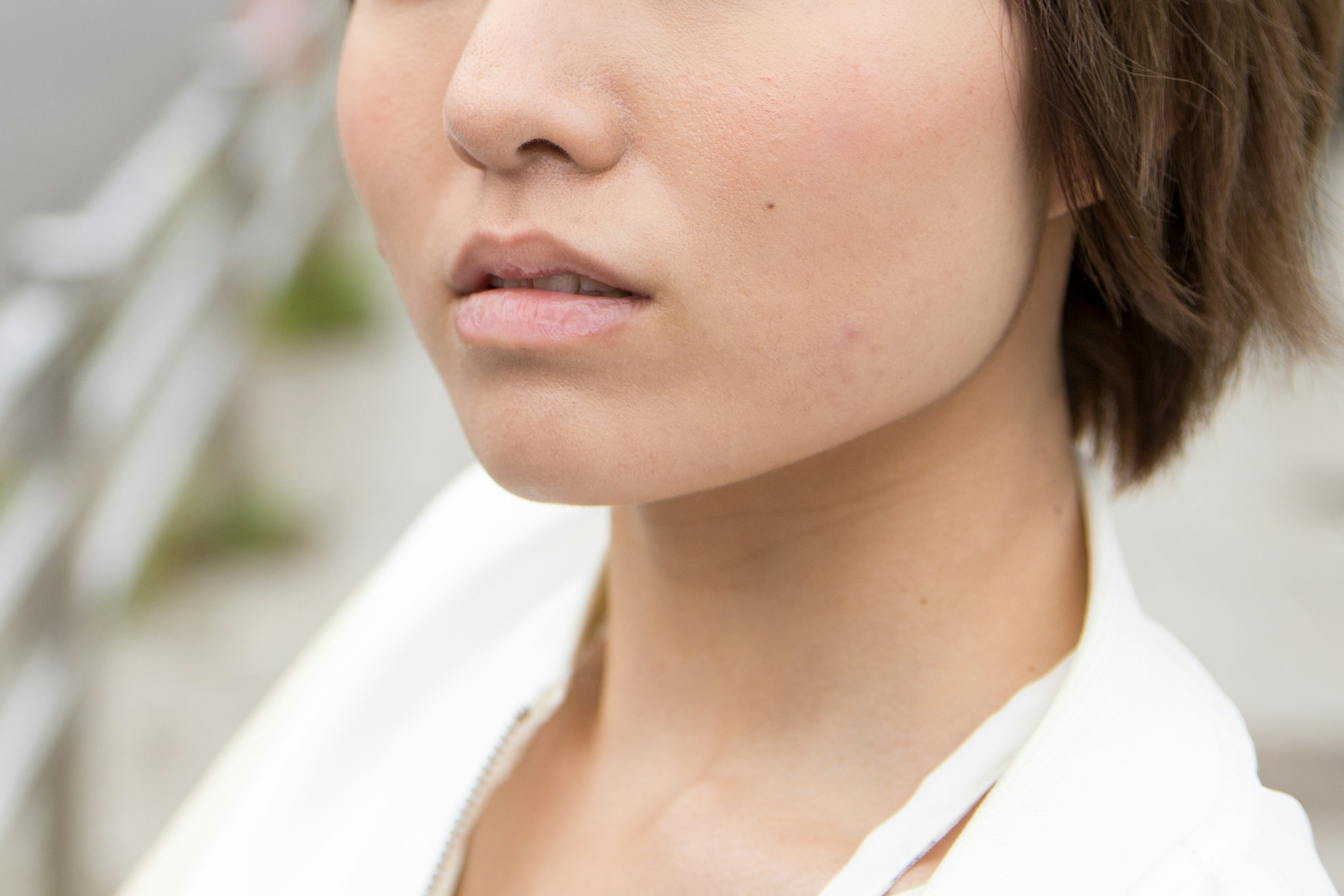 Portrait of a woman with short hair wearing a white outfit