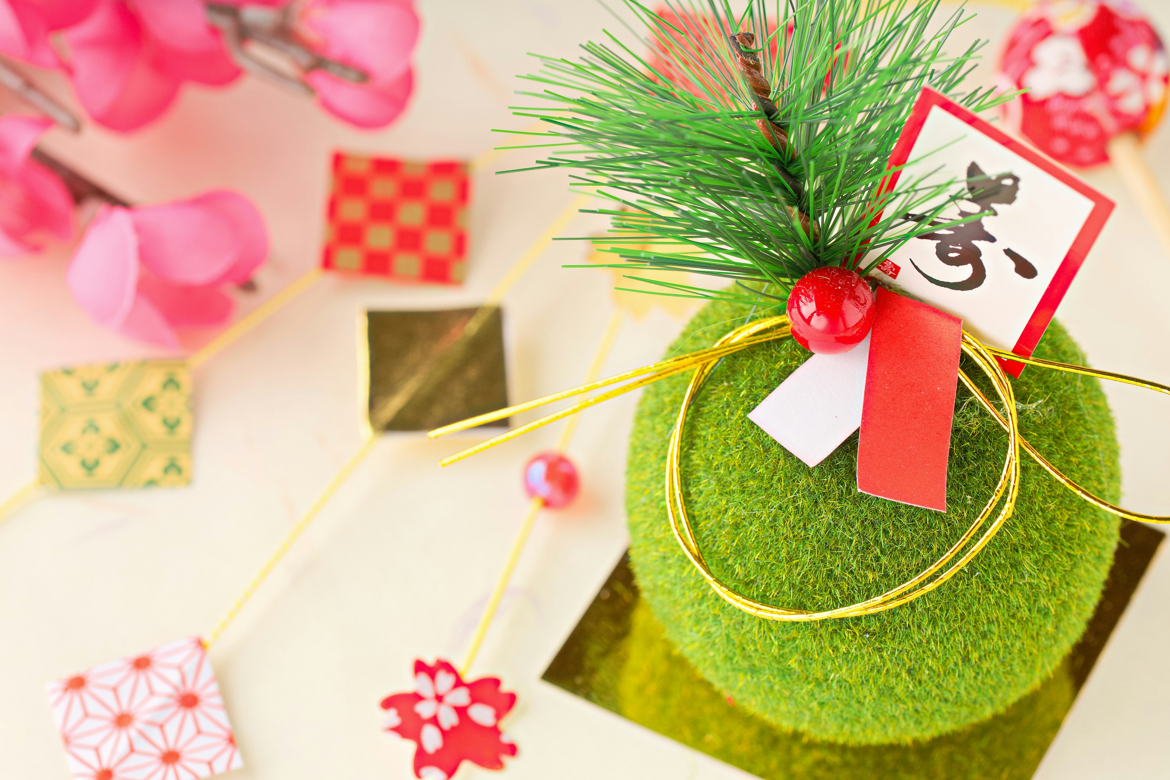 Beautiful Japanese New Year decoration featuring a green ornament with a red ribbon and small card