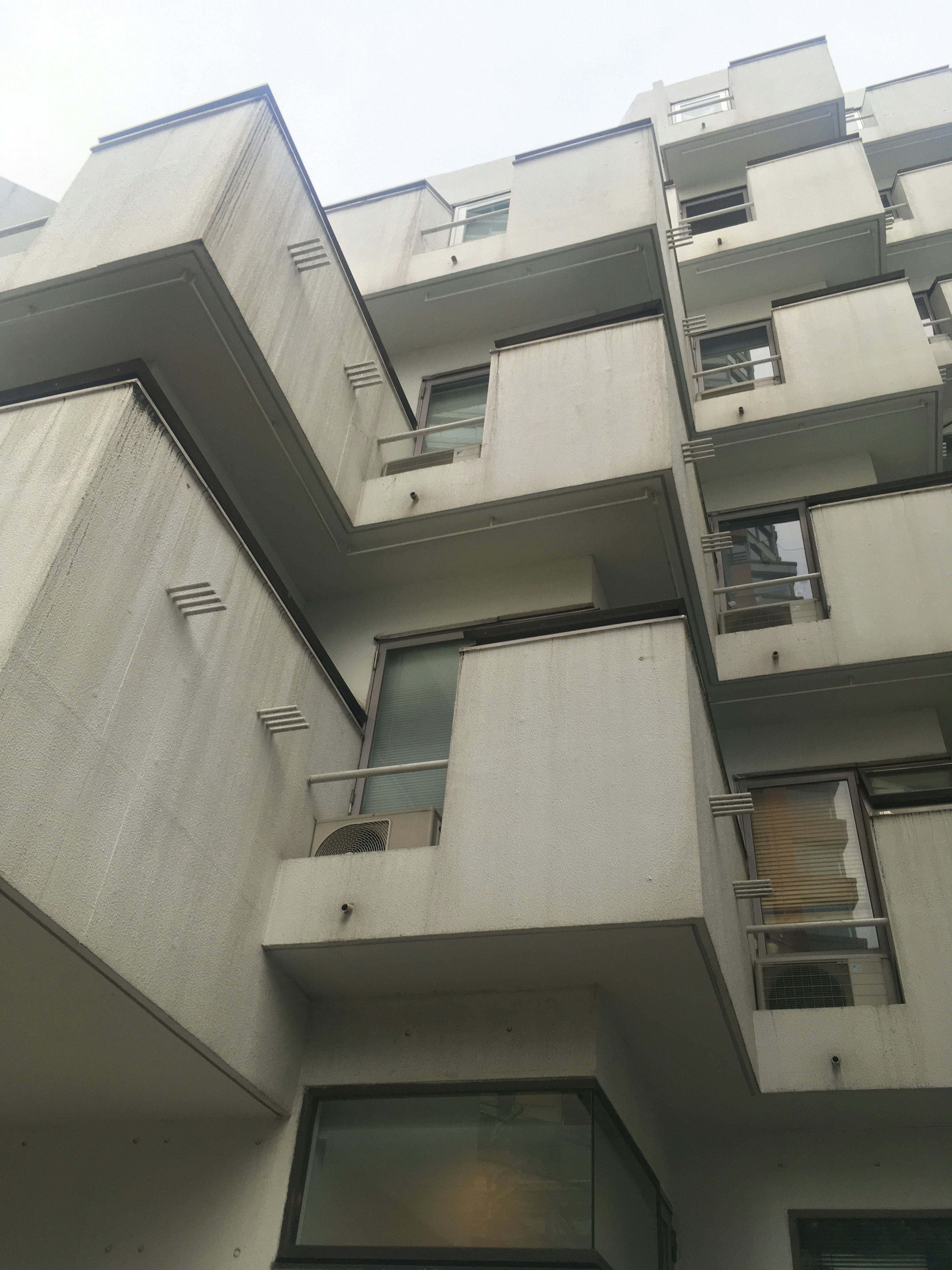 Modern building exterior with multiple balconies and large windows