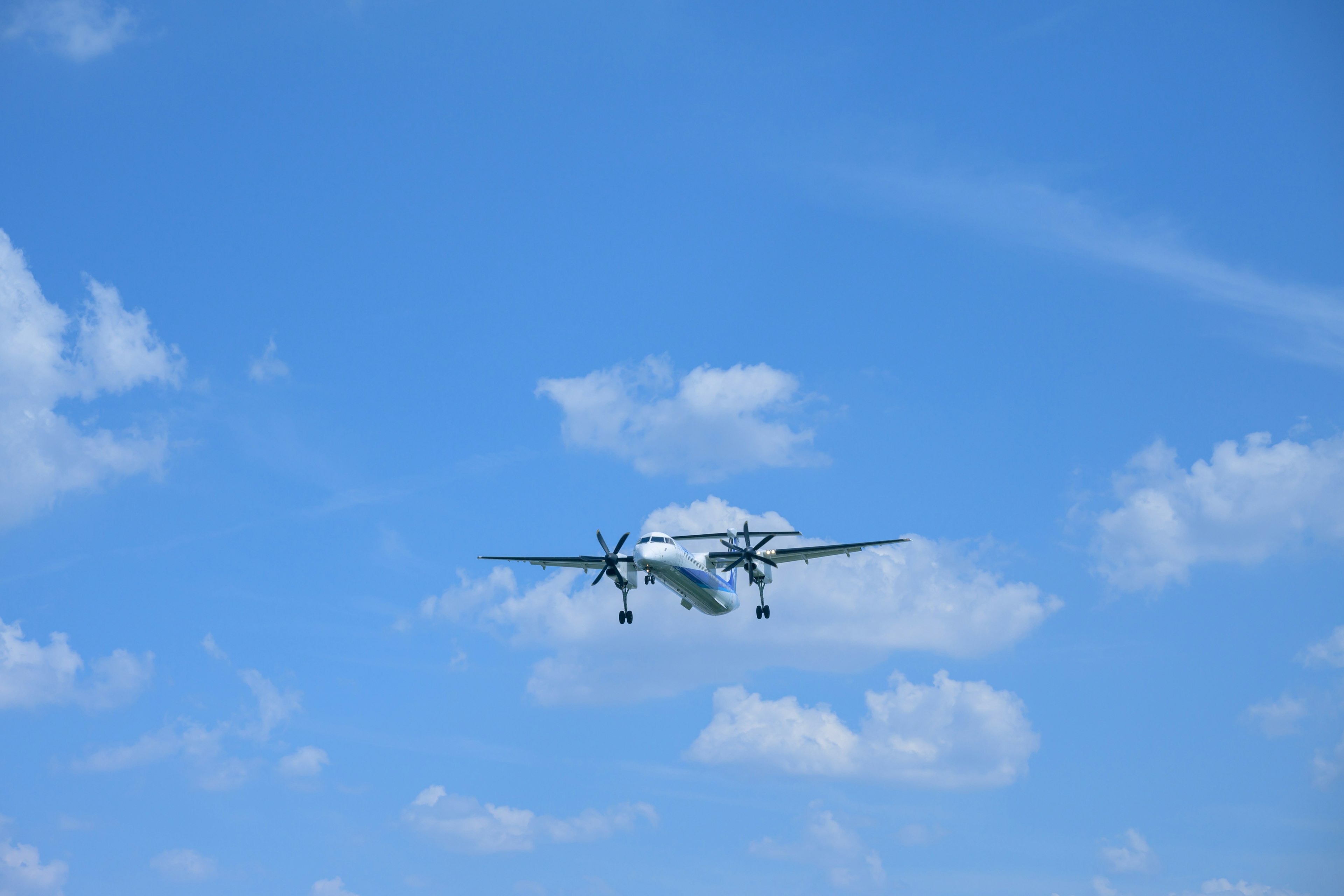 Twin-engine aircraft flying in a clear blue sky