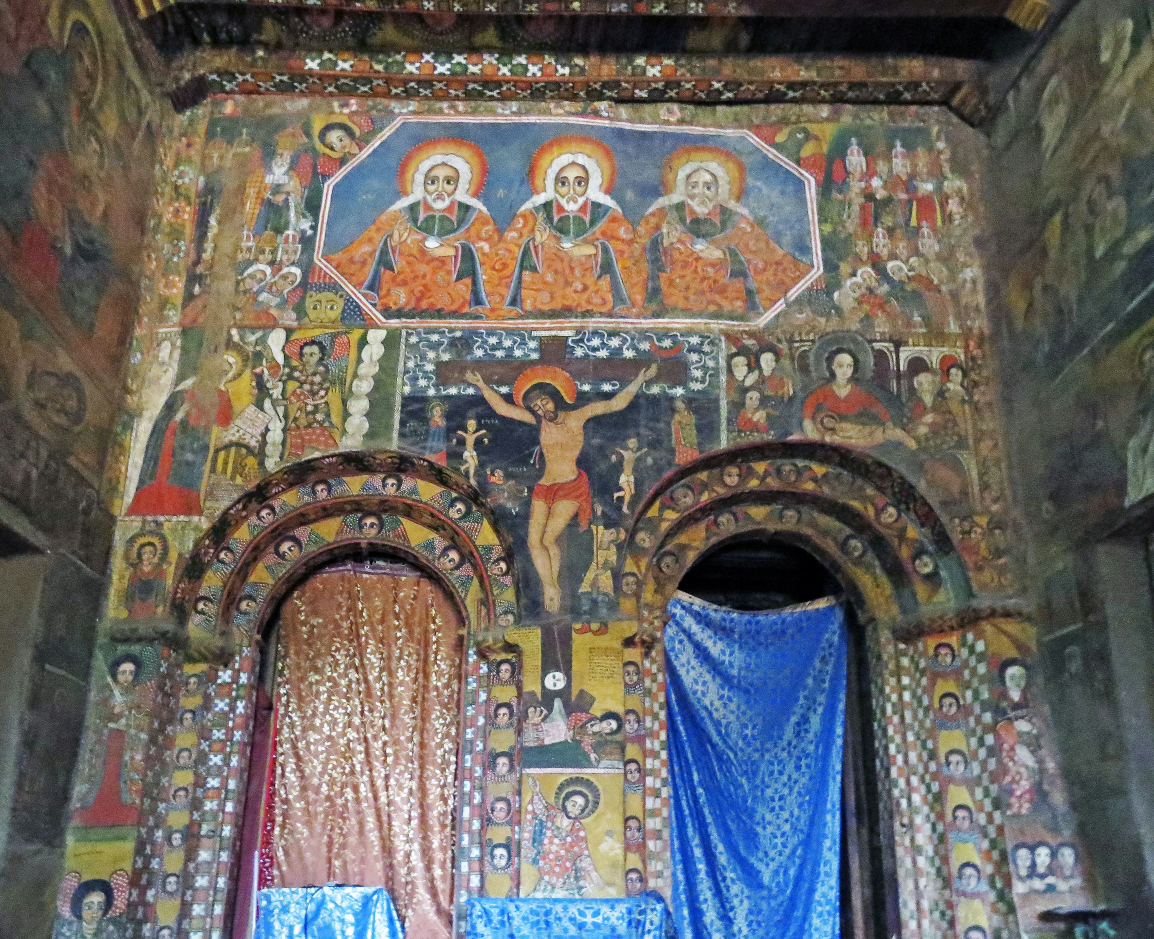 Interior of a church featuring vibrant frescoes and religious icons