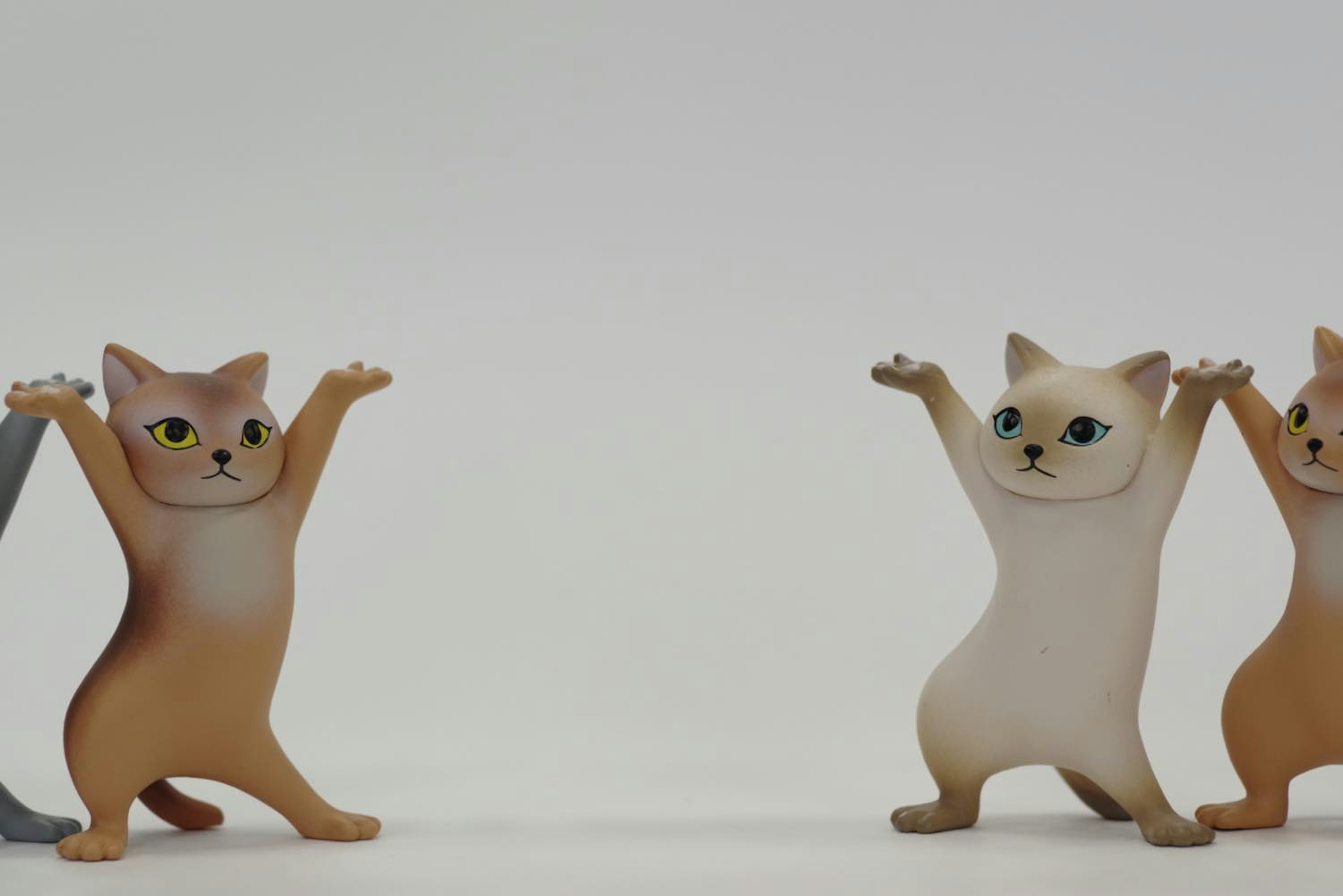 Cute cat figurines standing on both sides