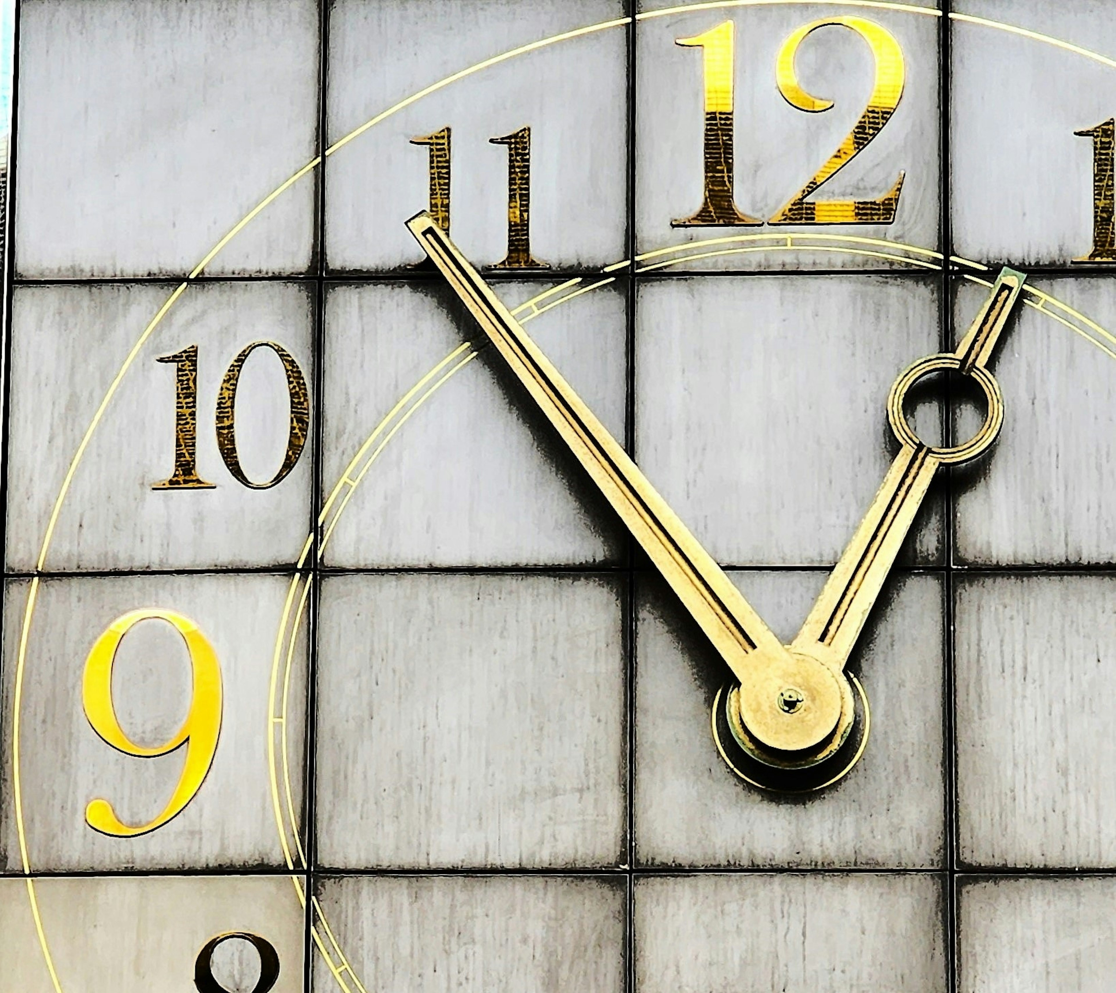 Close-up of a clock face with gold hands and numbers