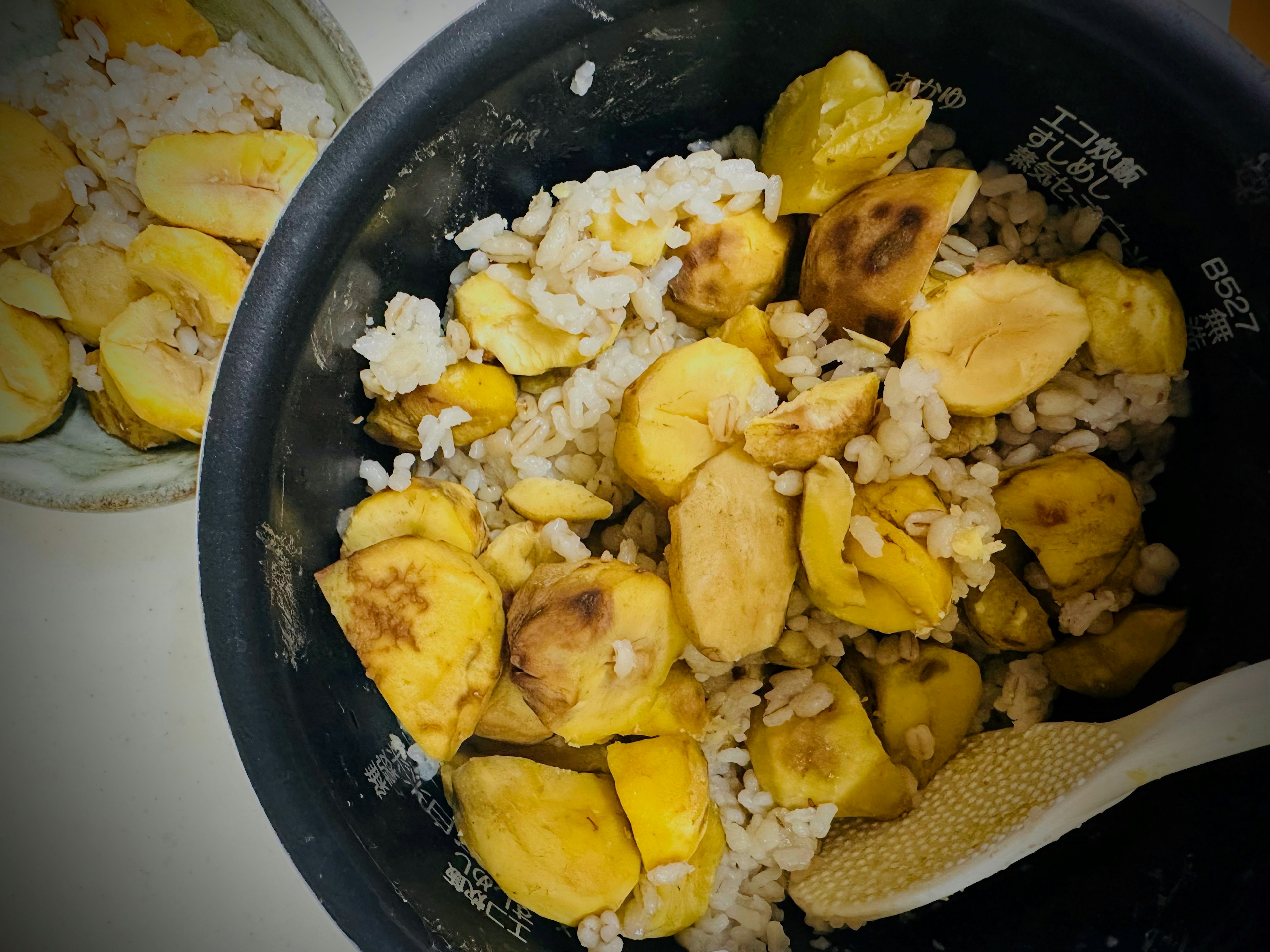 Rice cooker filled with mashed bananas and rice