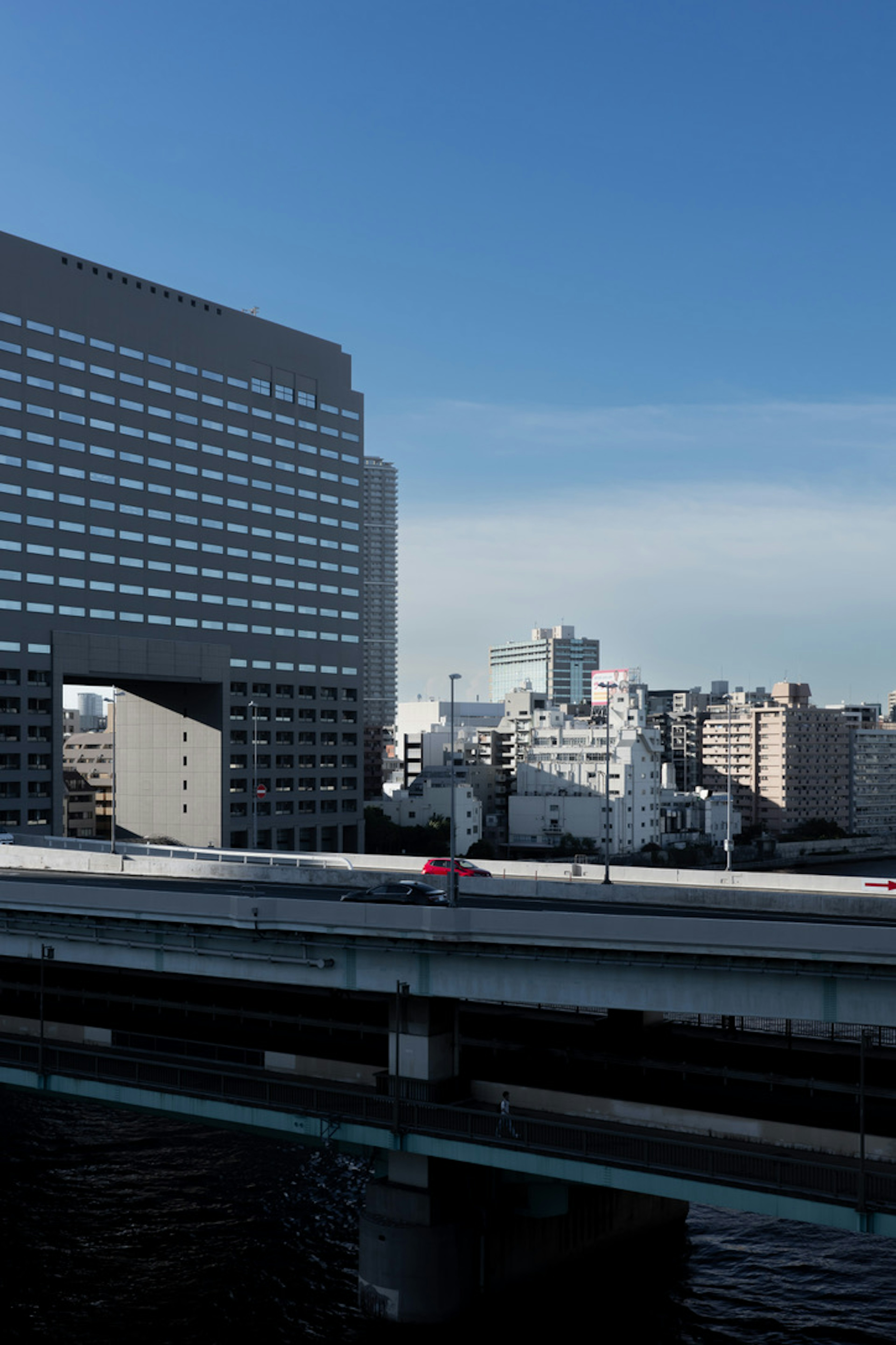 Modern buildings and highway under a clear blue sky