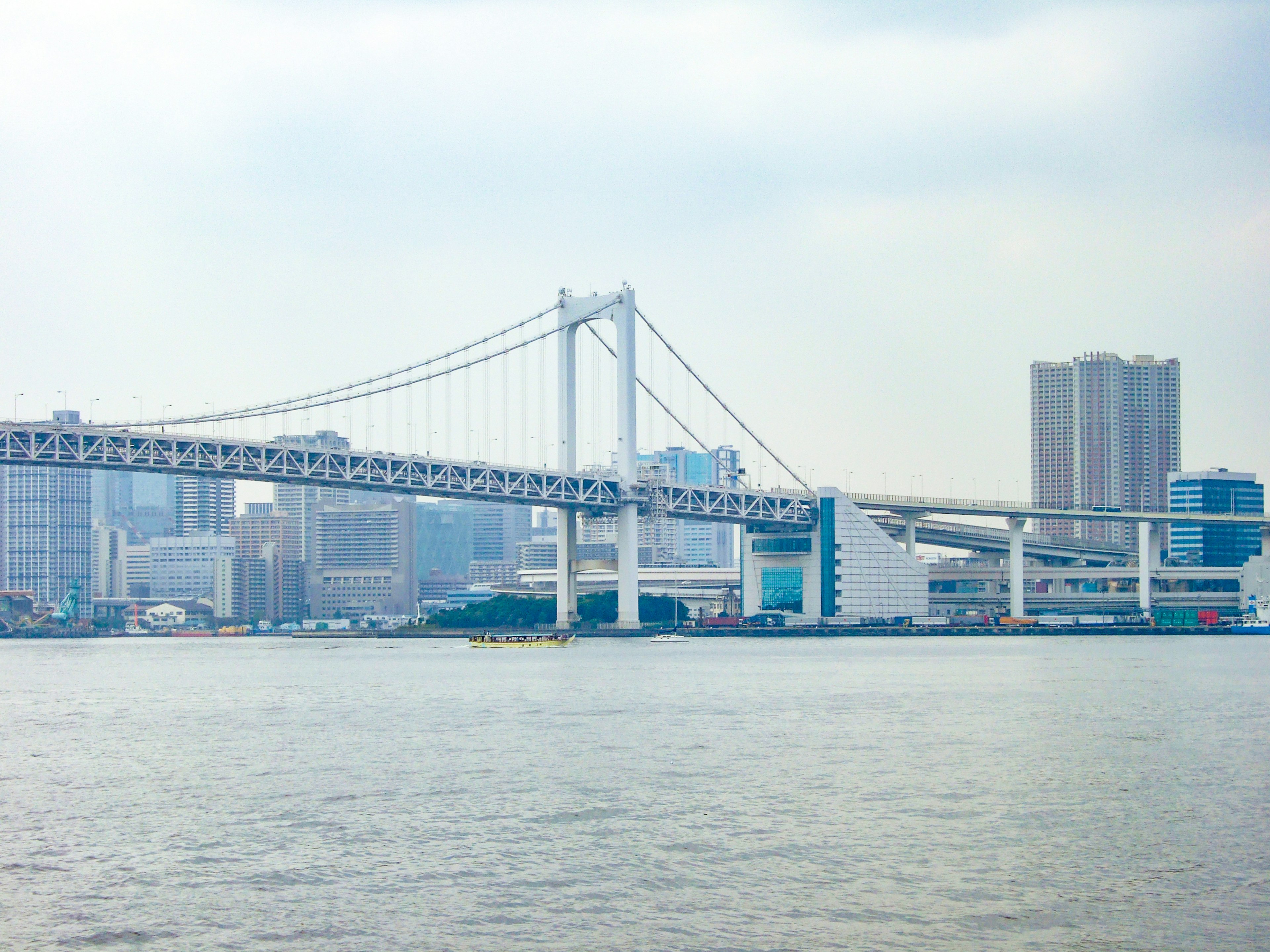 View of Rainbow Bridge with urban skyline