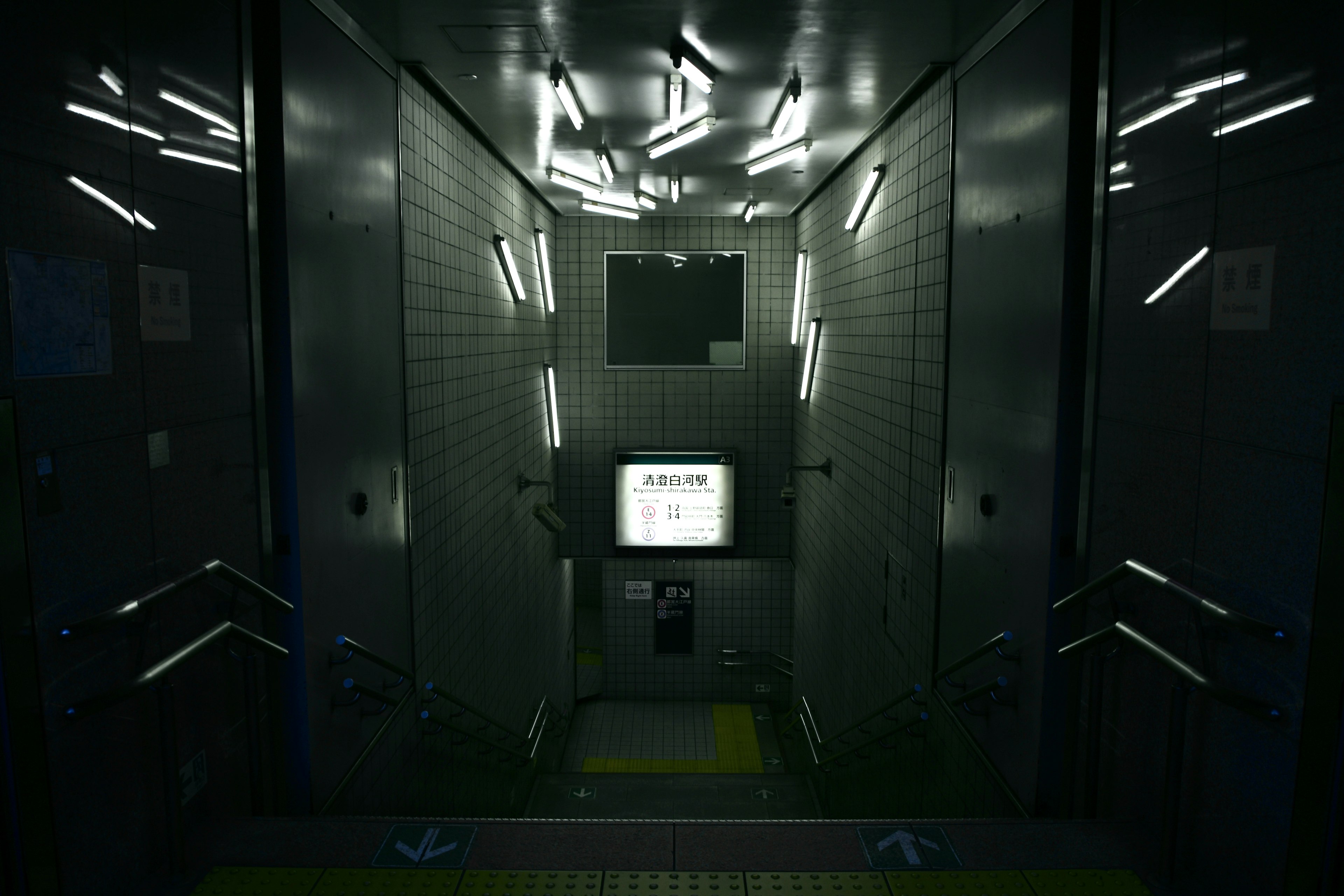 Dark elevator interior with glowing strip lights and a monitor