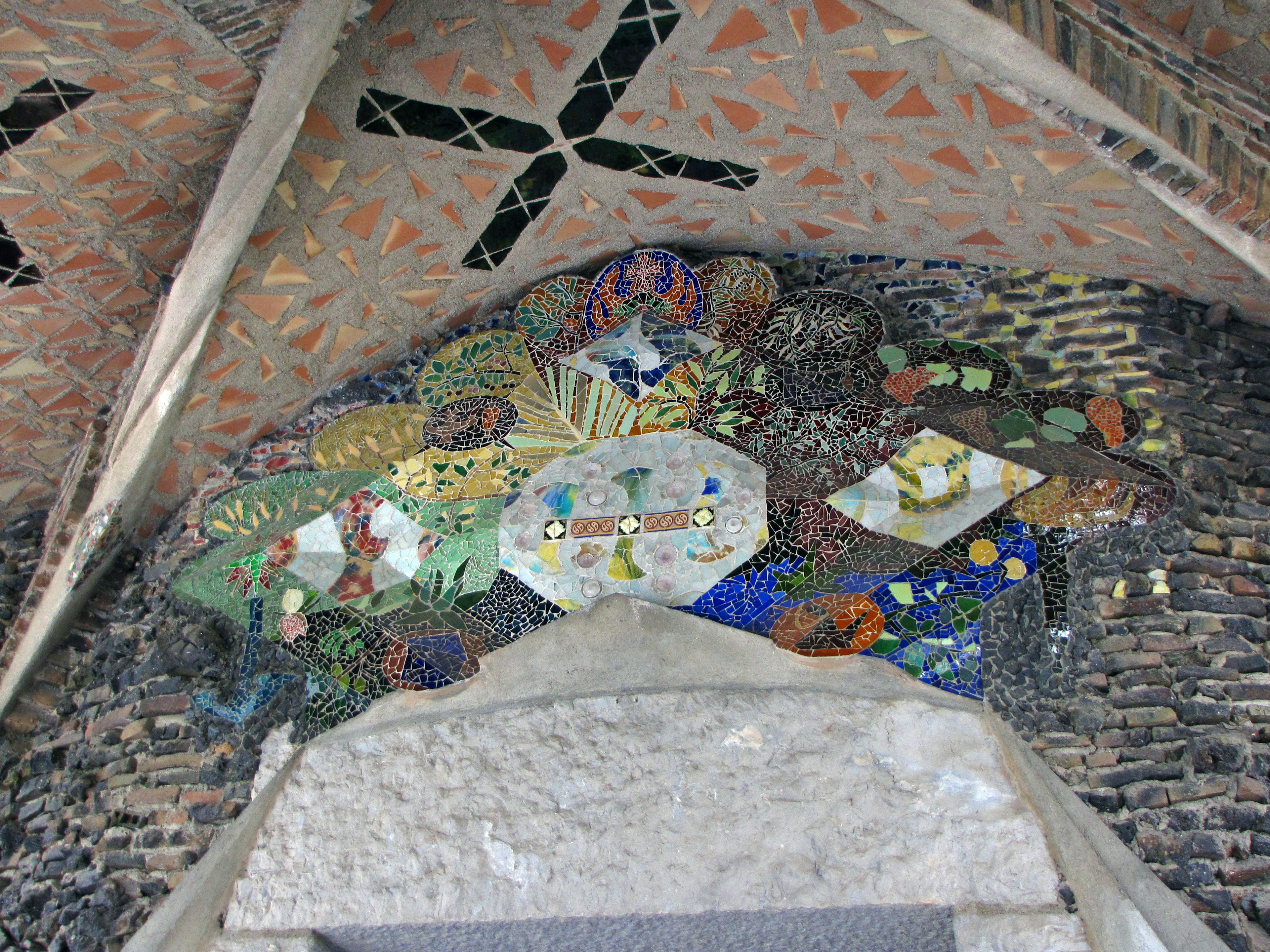 Mosaic art on an arch ceiling featuring colorful tiles and intricate designs