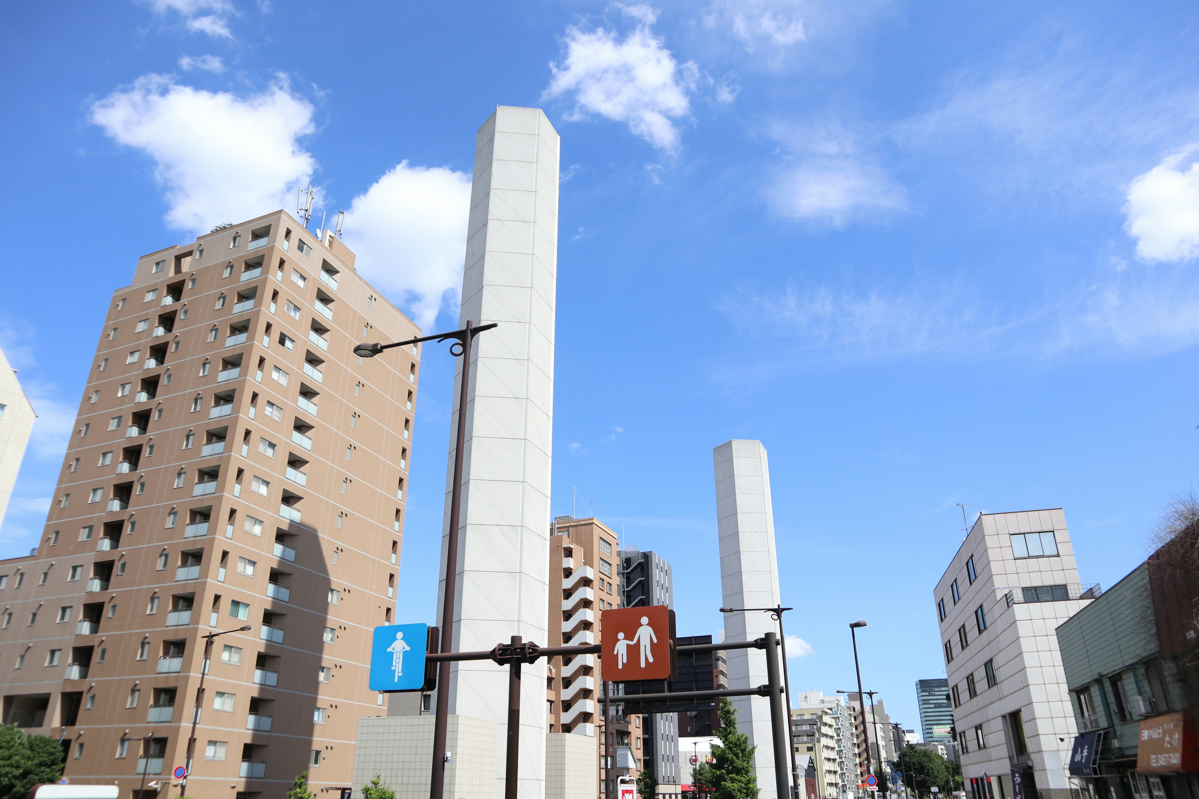 High-rise buildings and restroom signs under a blue sky