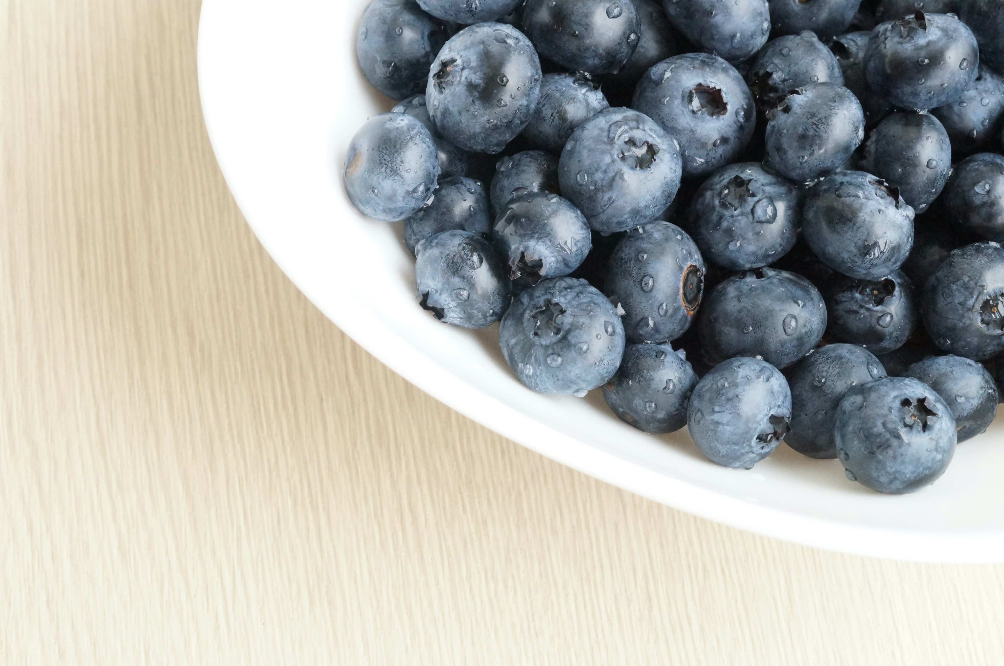 Close-up of fresh blueberries in a white bowl